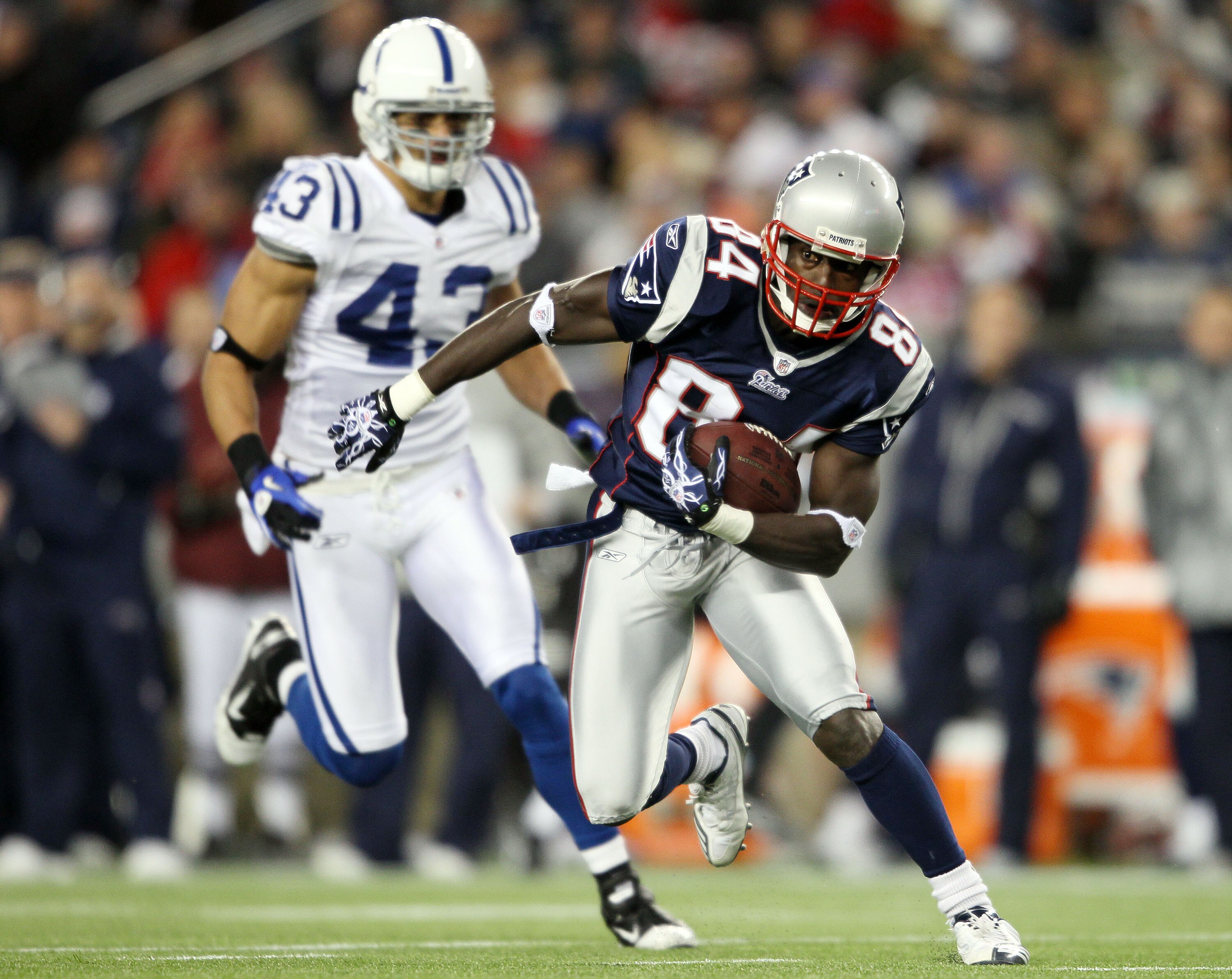 FOXBORO, MA - NOVEMBER 21:   Deion Branch #84 of the New England Patriots carries the ball as Aaron Francisco #43 of the Indianapolis Colts chases on November 21, 2010 at Gillette Stadium in Foxboro, Massachusetts. The Patriots defeated the Colts 31-28. (