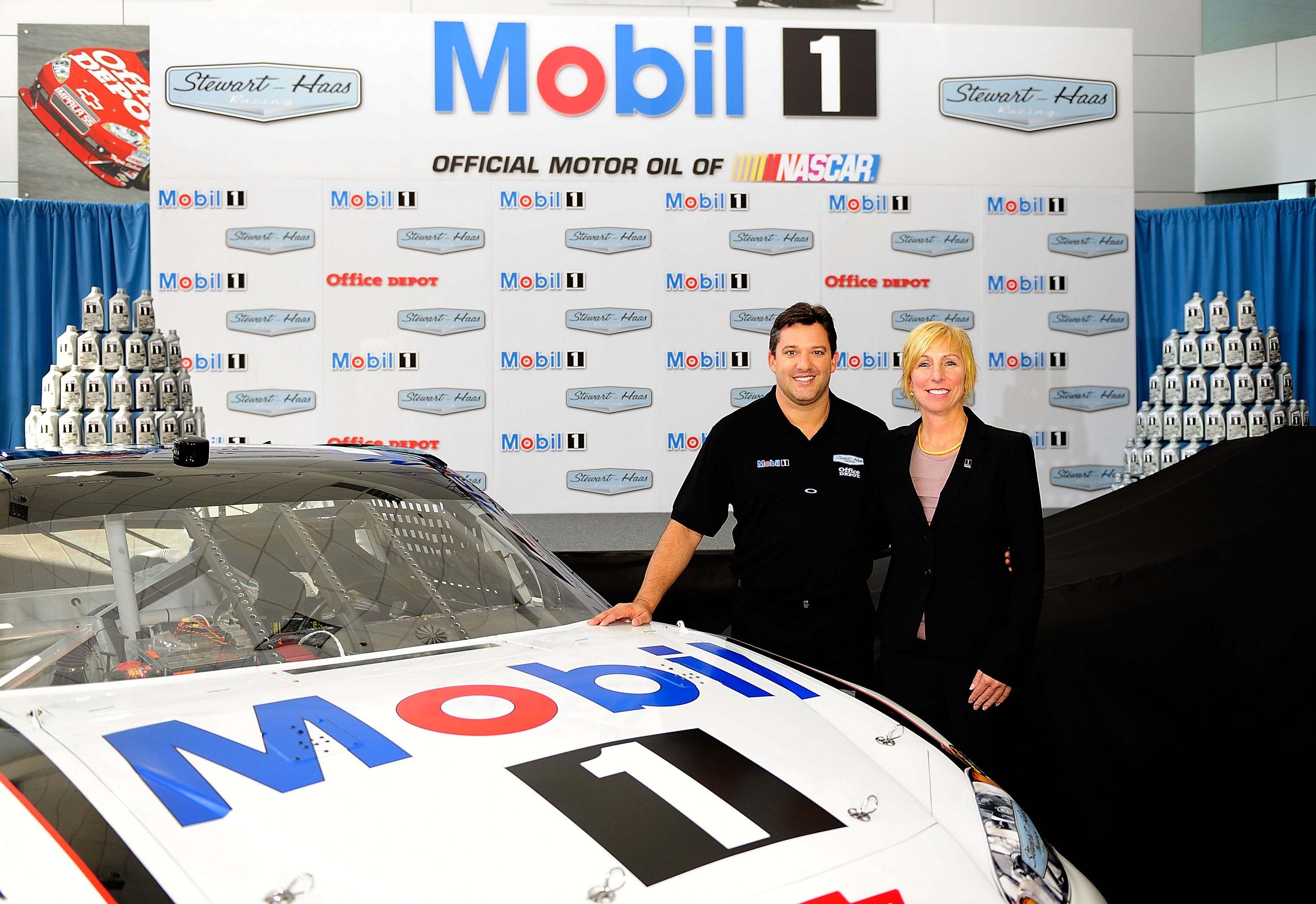 KANNAPOLIS, NC - OCTOBER 12:  Rebecca Rahaim, Mobil 1 Global Brand Manager, and Tony Stewart, Stewart-Haas Racing's driver/owner, pose for pictures to announce Mobil 1 as his co-primary sponsor with Office Depot beginning in 2011 at Stewart-Haas Racing on