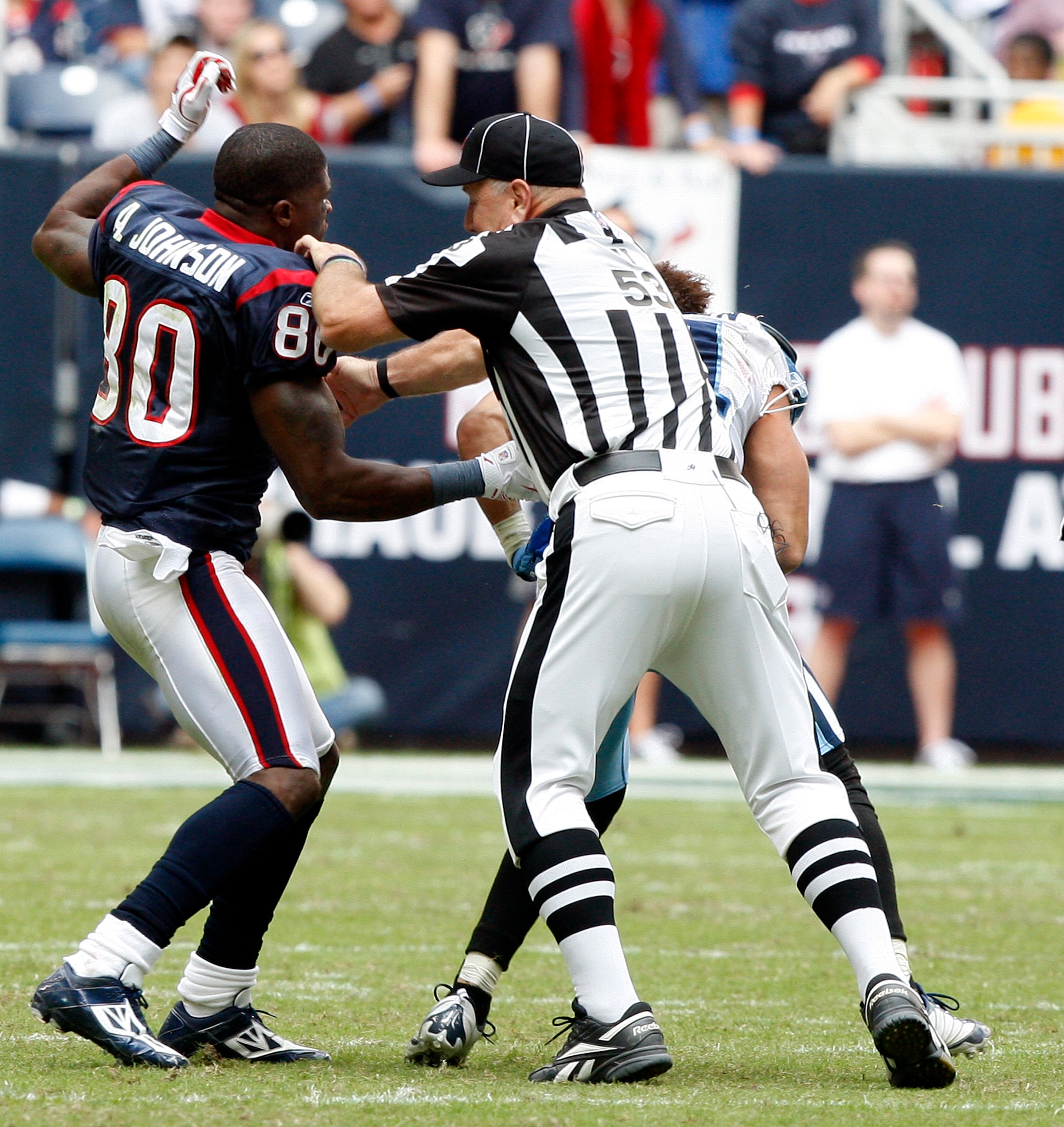 HOUSTON - NOVEMBER 28:  Wide receiver Andre Johnson #80 of the Houston Texans is separated by umpire Garth DeFerlice #53 from cornerback Cortland Finnegan #31 of the Tennessee Titans after the two exchanged punches in the fourth quarter at Reliant Stadium
