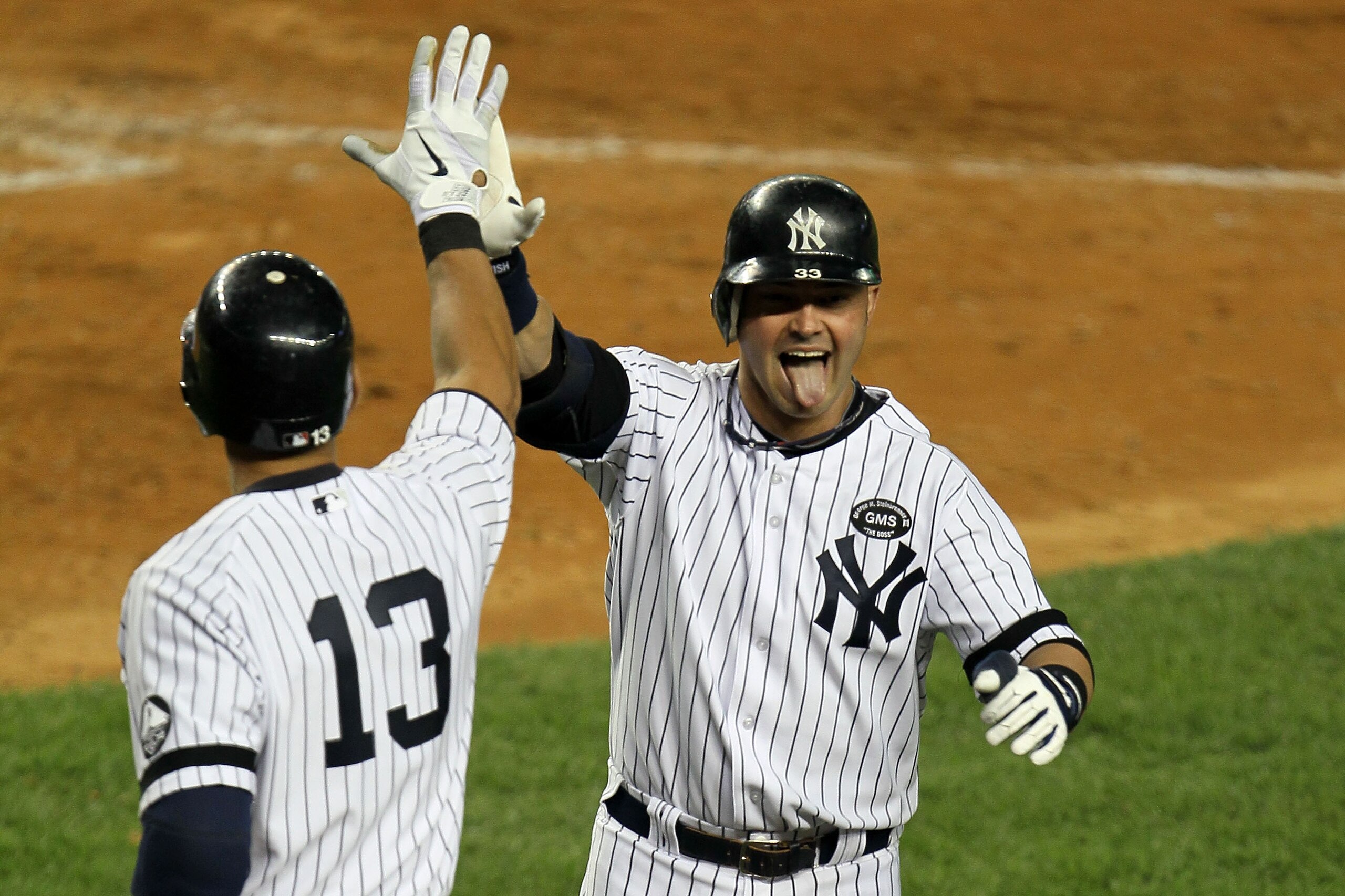 NEW YORK - OCTOBER 09:  Nick Swisher #33 (R) of the New York Yankees celebrates with Alex Rodriguez #13 after Swisher scored on a solo home run in the bottom of the seventh inning against the Minnesota Twins during Game Three of the ALDS part of the 2010