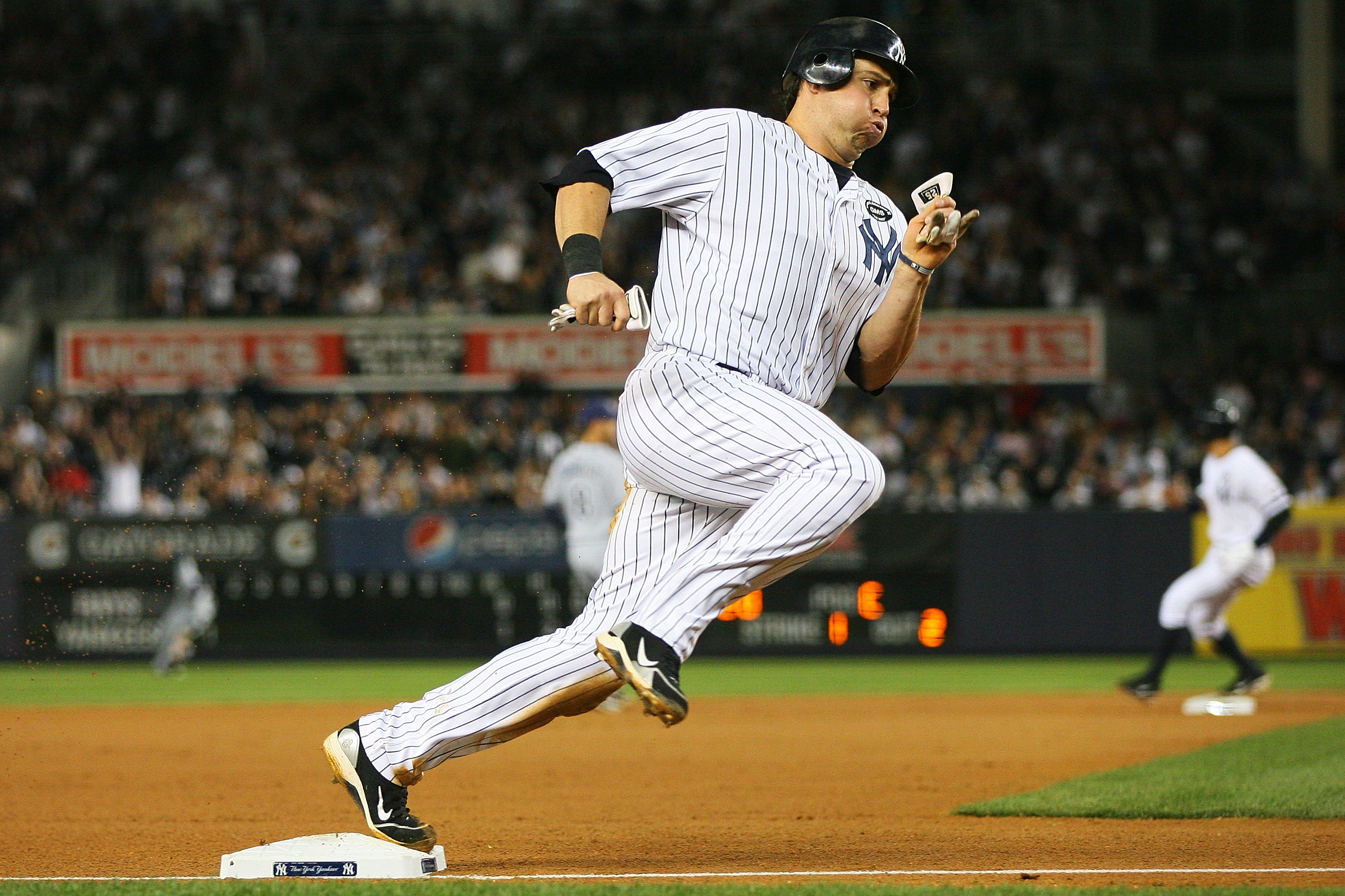 NEW YORK - SEPTEMBER 21:  Mark Teixeira #25 of the New York Yankees rounds third base on a one run single hit by Jorge Posada against the Tampa Bay Rays on September 21, 2010 at Yankee Stadium in the Bronx borough of New York City.  (Photo by Andrew Burto