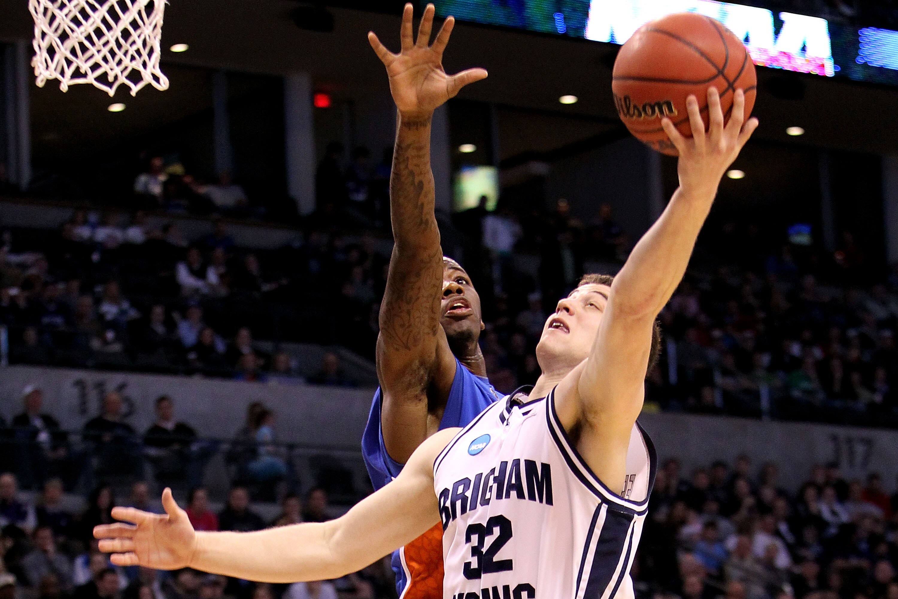 OKLAHOMA CITY - MARCH 18:  Jimmer Fredette #32 of the BYU Cougars drives for a shot attempt against Kenny Boynton #1 of the Florida Gators during the first round of the 2010 NCAA menï¿½s basketball tournament at Ford Center on March 18, 2010 in Oklahoma Cit