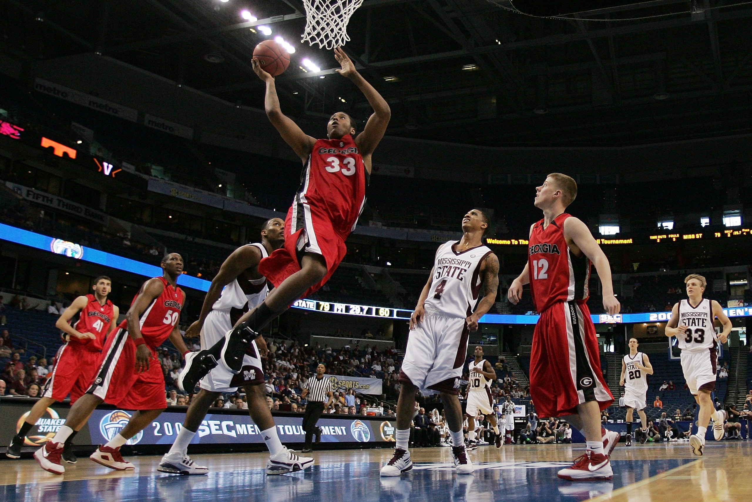TAMPA, FL - MARCH 12:  Trey Thompkins #33 of the Georgia Bulldogs makes a shot over Romero Osby #5 of the Mississippi State Bulldogs during the first round of the SEC Men's Basketball Tournament on March 12, 2009 at The St. Pete Times Forum in Tampa, Flor