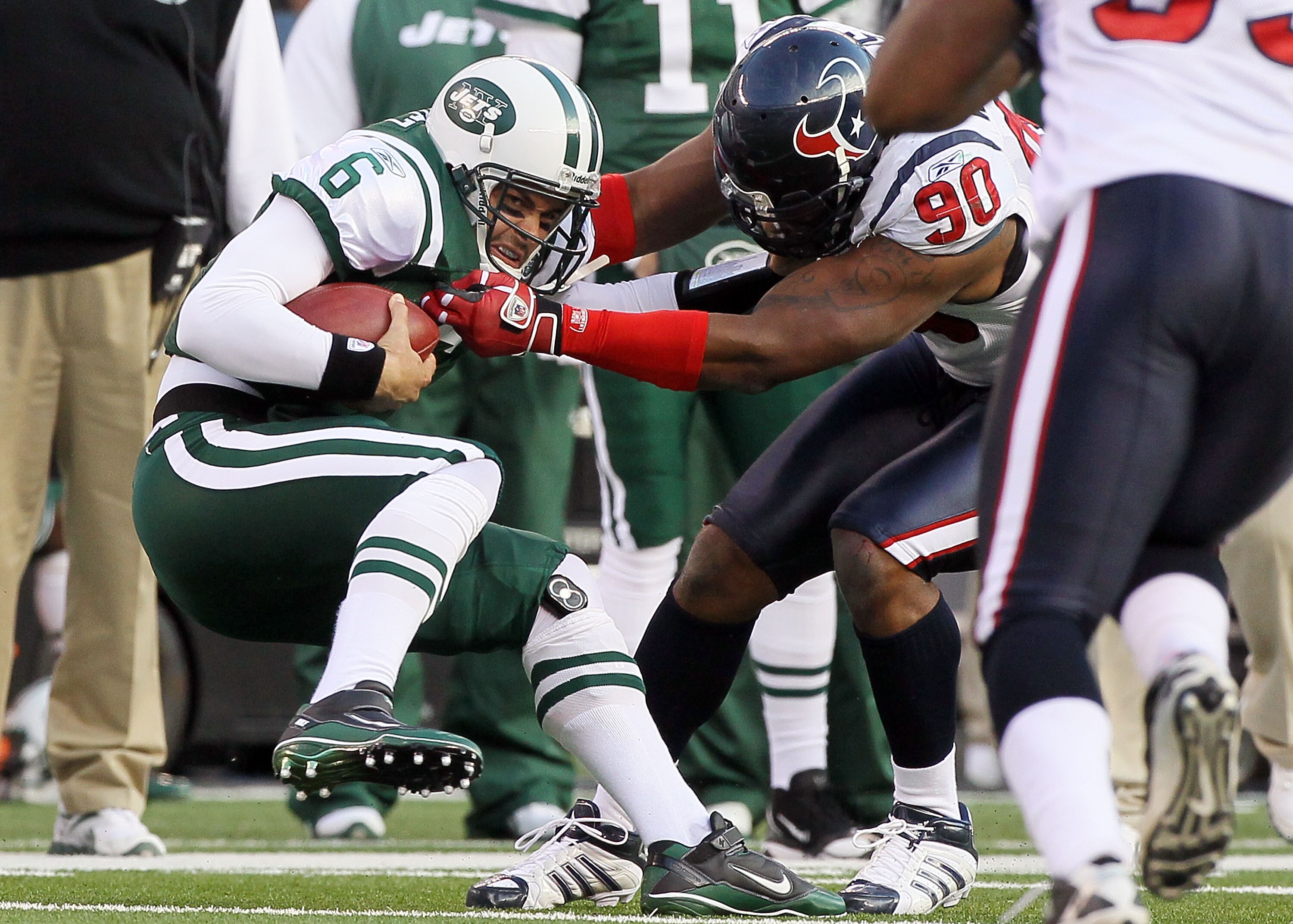 EAST RUTHERFORD, NJ - NOVEMBER 21:  Mark Sanchez #6 of the New York Jets is sacked by Mario Williams #90 of the Houston Texans on November 21, 2010 at the New Meadowlands Stadium in East Rutherford, New Jersey.  (Photo by Jim McIsaac/Getty Images)