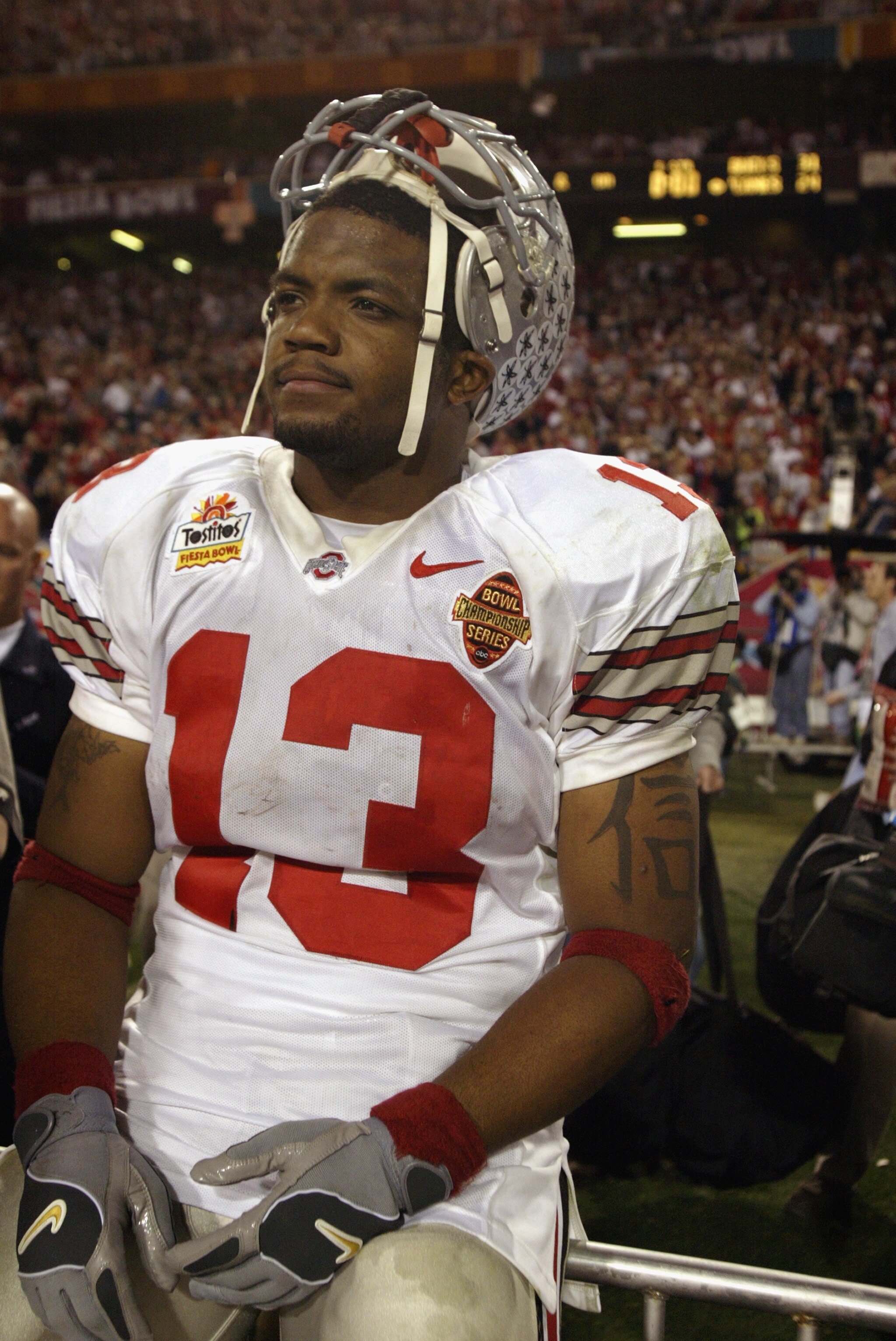 TEMPE, AZ - JANUARY 3:  Freshman running back Maurice Clarett #13 of the Ohio State Buckeyes takes in the BCS Championship victory over the University of Miami Hurricanes in the Tostitos Fiesta Bowl at Sun Devil Stadium on January 3, 2003  in Tempe, Arizo