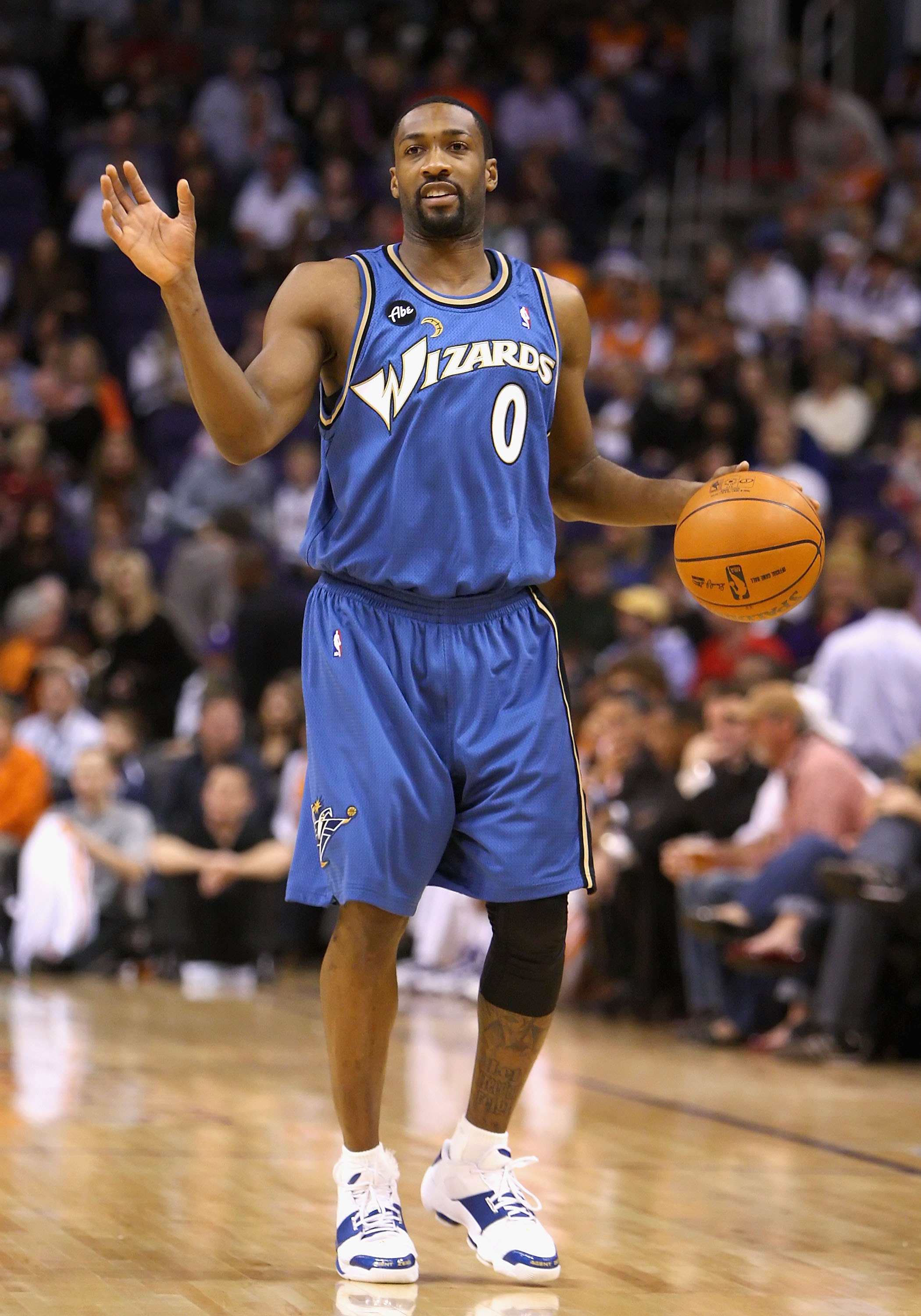PHOENIX - DECEMBER 19:  Gilbert Arenas #0 of the Washington Wizards hanldles the ball during the NBA game against the Phoenix Suns at US Airways Center on December 19, 2009 in Phoenix, Arizona. The Suns defeated the Wizards 121-95. NOTE TO USER: User expr