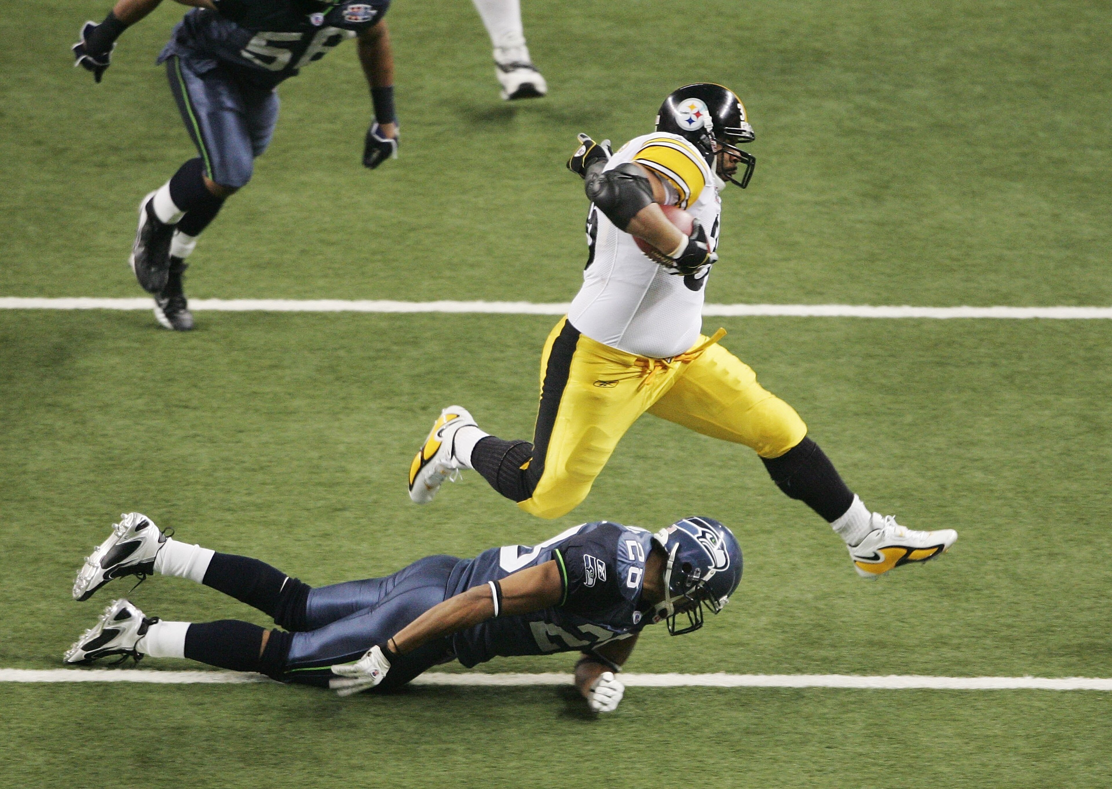 DETROIT - FEBRUARY 05:  Runningback Jerome Bettis #36 of the Pittsburgh Steelers leaps over Michael Boulware #28 of the Seattle Seahawks while carrying the football in the third quarter in Super Bowl XL at Ford Field on February 5, 2006 in Detroit, Michig