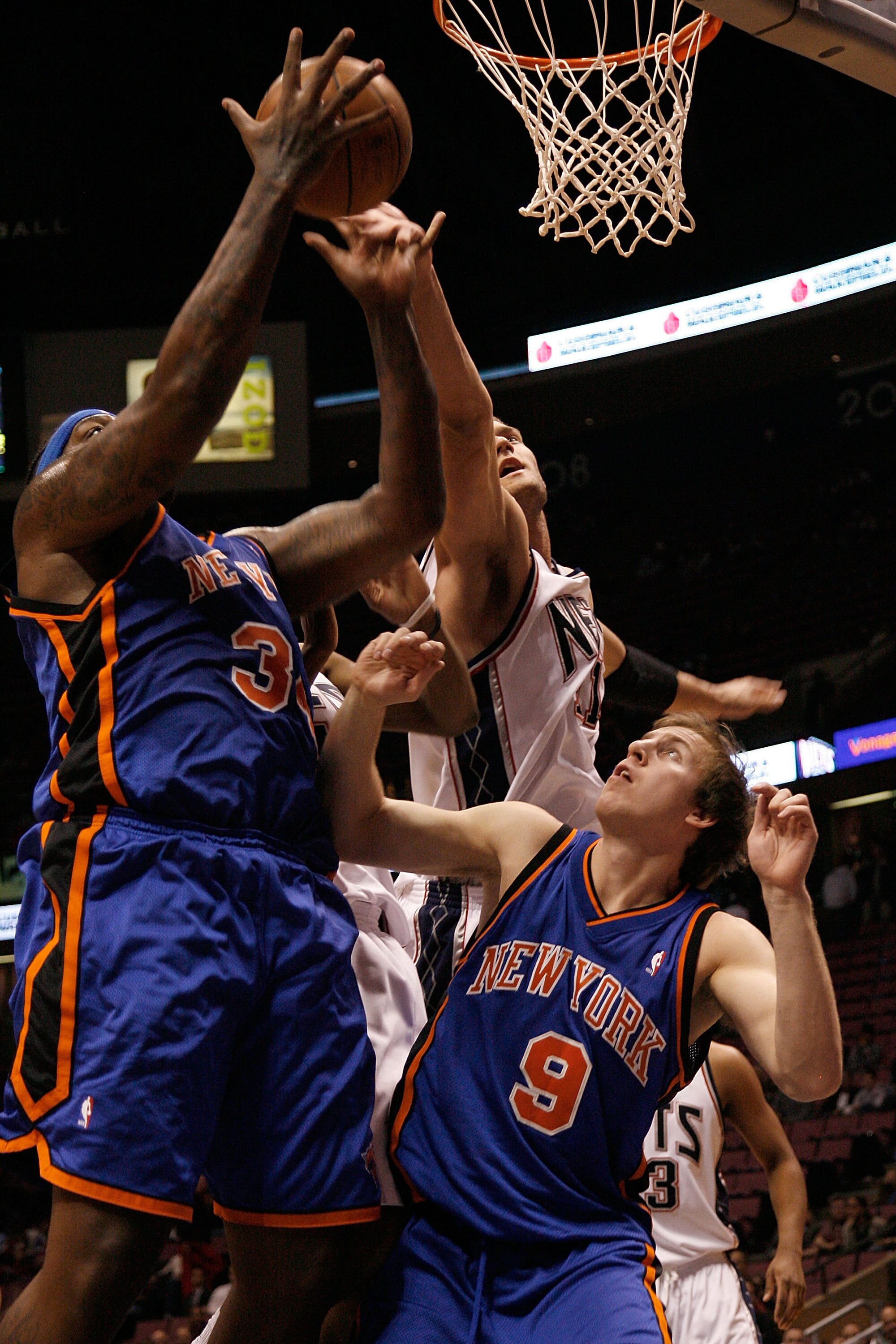 EAST RUTHERFORD, NJ - OCTOBER 20: Eddie Curry #34 and Dan Grunfeld #9 of the New York Knicks go up for a rebound during the second half against the New Jersey Nets  on October 20, 2008 at the IZOD Center in East Rutherford, New Jersey. The Knicks won 114-