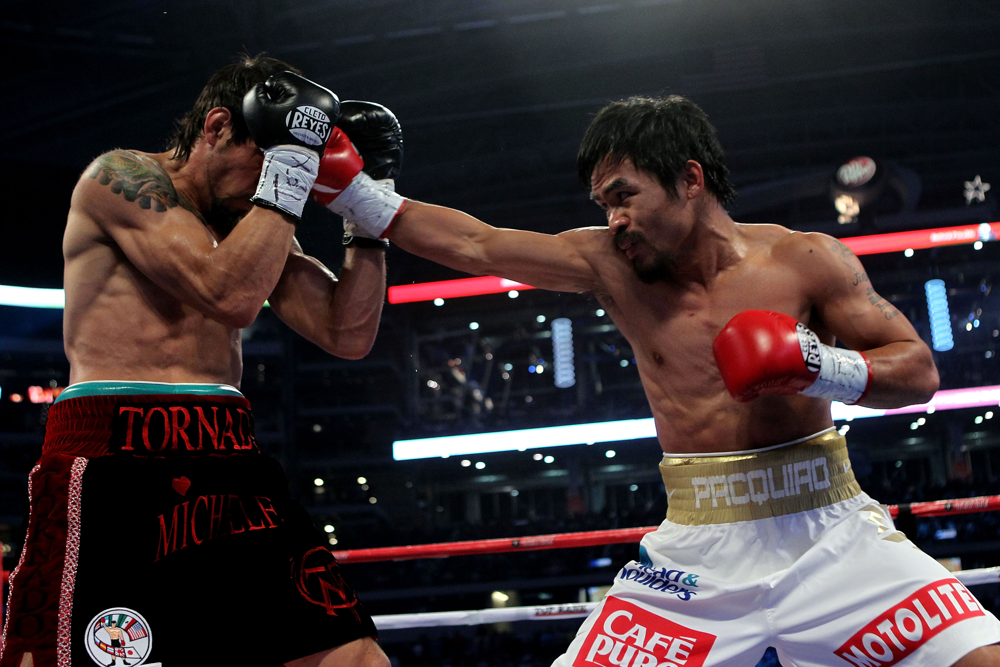ARLINGTON, TX - NOVEMBER 13:  Manny Pacquiao (white trunks) of the Philippines lands a punch against Antonio Margarito (black trunks) of Mexico during their WBC World Super Welterweight Title bout at Cowboys Stadium on November 13, 2010 in Arlington, Texa