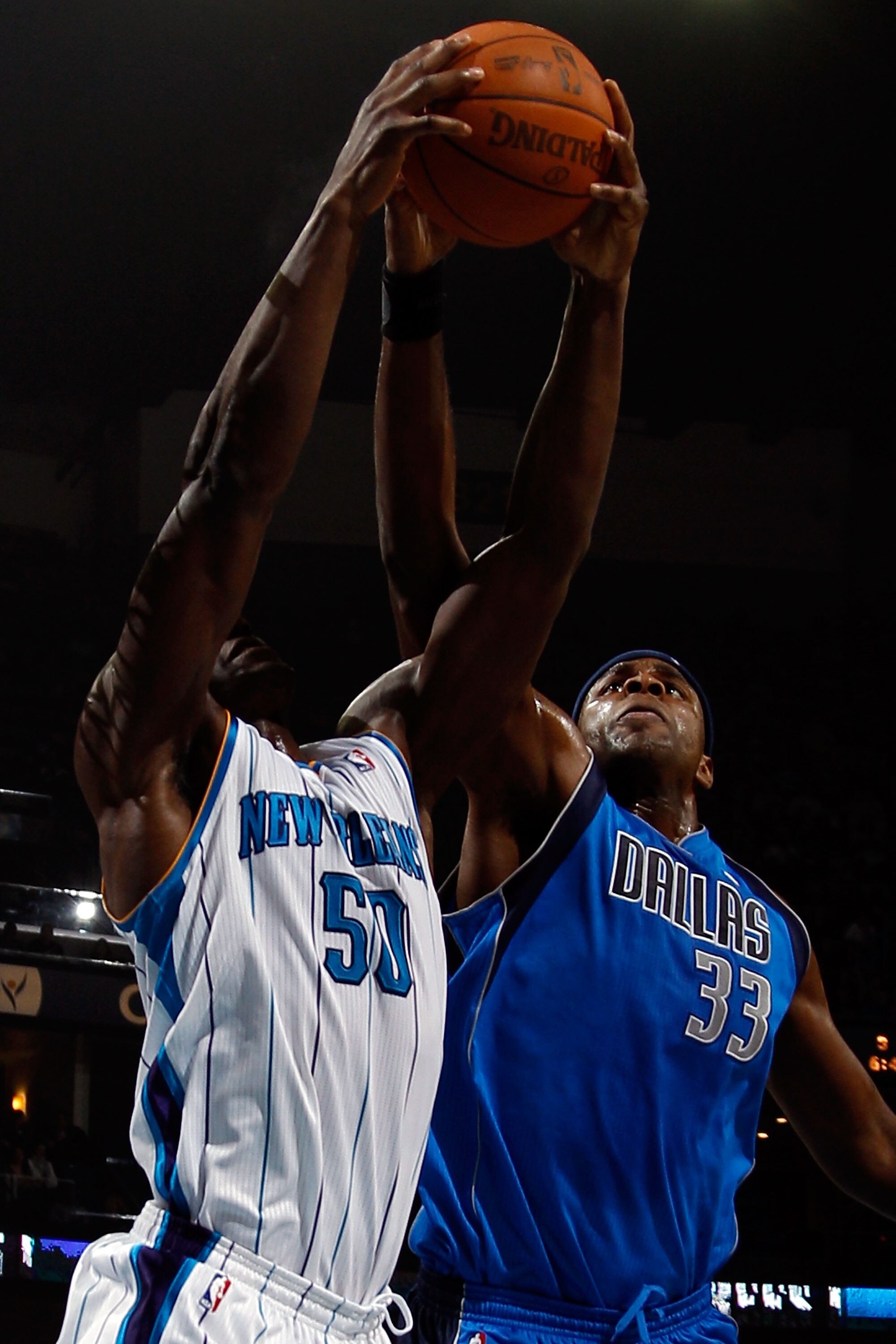 NEW ORLEANS - NOVEMBER 17:  Emeka Okafor #50 of the New Orleans Hornets fights for a rebound with Brendan Haywood #33 of the Dallas Mavericks at the New Orleans Arena on November 17, 2010 in New Orleans, Louisiana.  NOTE TO USER: User expressly acknowledg