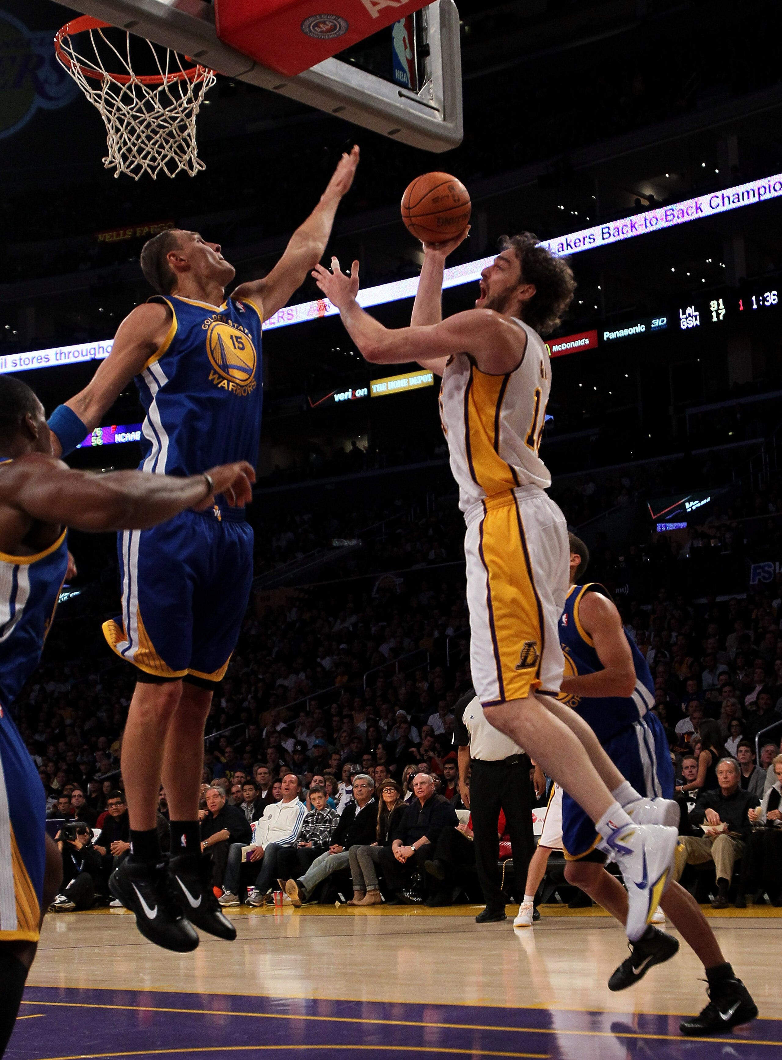 LOS ANGELES - NOVEMBER 21: Pau Gasol #16 of the Los Angeles Lakers shoots over Andris Biedrins #15 of the Golden State Warriors at Staples Center on November 21, 2010 in Los Angeles, California. NOTE TO USER: User expressly acknowledges and agrees tha LOS ANGELES - NOVEMBER 21: Pau Gasol #16 of the Los Angeles Lakers shoots over Andris Biedrins #15 of the Golden State Warriors at Staples Center on November 21, 2010 in Los Angeles, California. NOTE TO USER: User expressly acknowledges and agrees tha