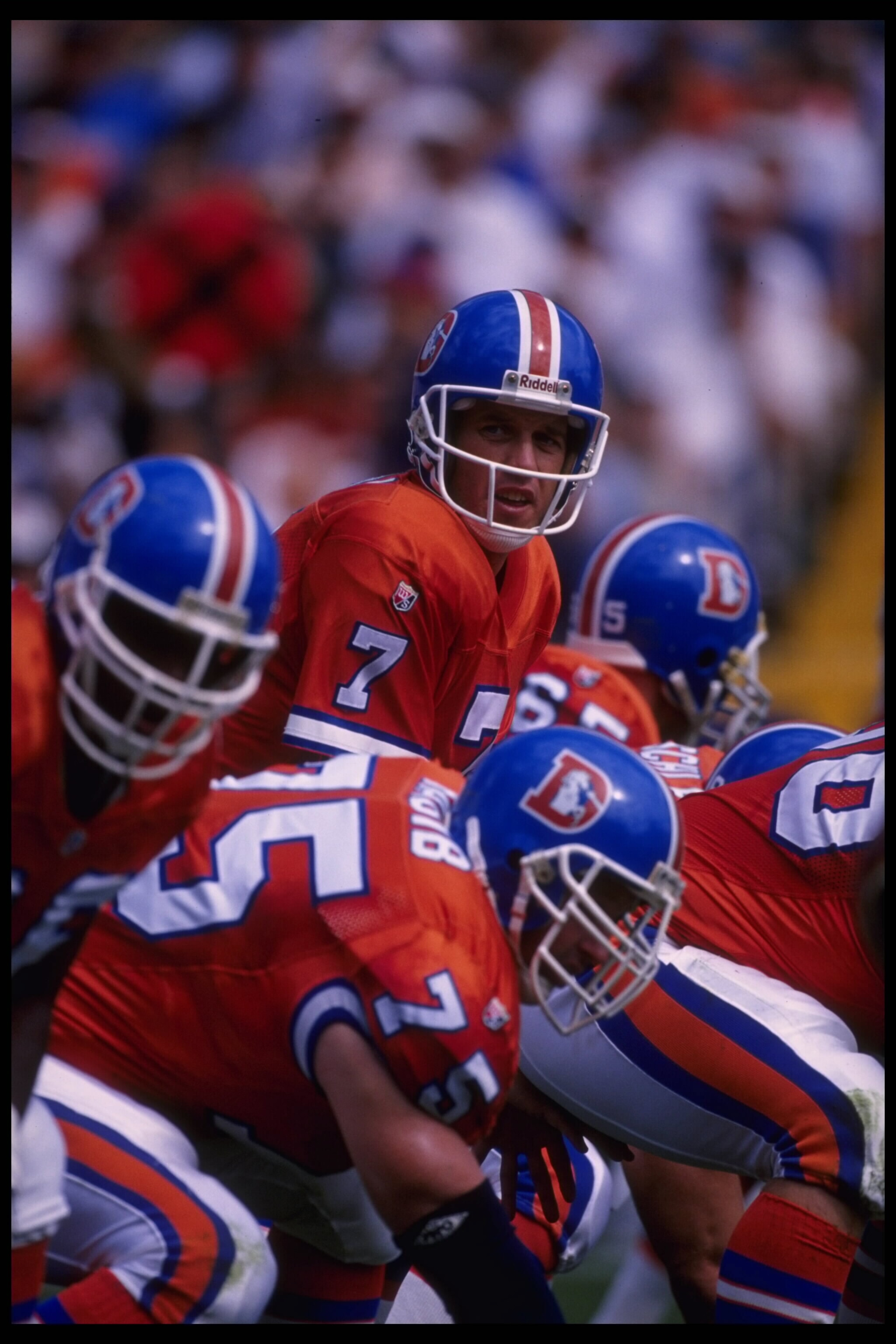 17 Sep 1995: Quarterback John Elway #7 of the Denver Broncos crouches to receive the snap behind tackle Brian Habab #75 at Mile High Stadium in Denver, Colorado, during the game against the Washington Redskins. The Broncos defeated the Redskins 38-31.