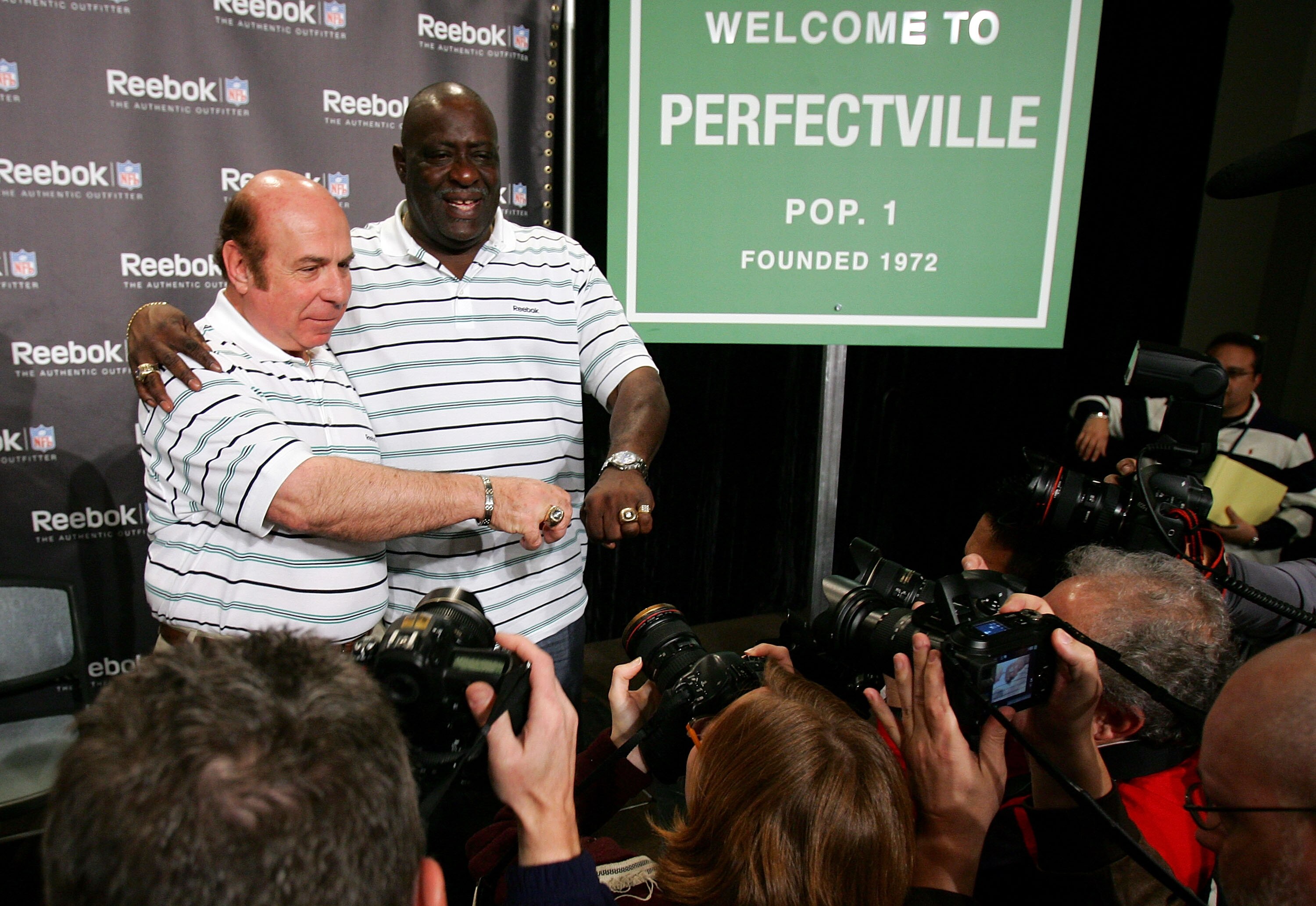 PHOENIX - FEBRUARY 01:  Former Miami Dolphins, Garo Yepremian (L) and Larry Little show off their Superbowl rings to photographers during a press conference anouncing Reebok's new television campaign -dubbed 'Perfectville'- featuring members of the only u