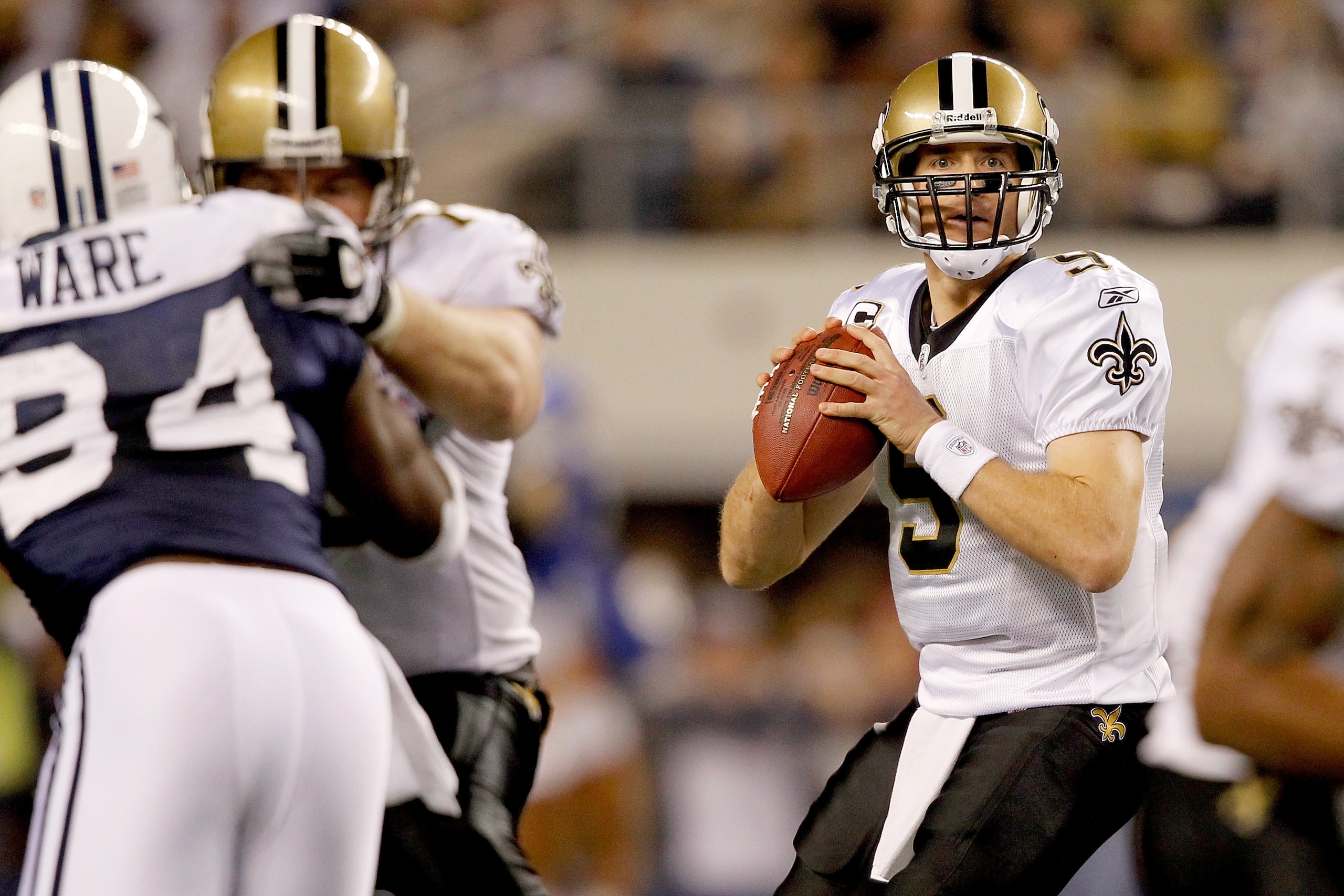 ARLINGTON, TX - NOVEMBER 25: Quarterback Drew Brees #9 of the New Orleans Saints looks for an open receiver while playing the Dallas Cowboys at Cowboys Stadium on November 25, 2010 in Arlington, Texas. (Photo by Matthew Stockman/Getty Images) ARLINGTON, TX - NOVEMBER 25: Quarterback Drew Brees #9 of the New Orleans Saints looks for an open receiver while playing the Dallas Cowboys at Cowboys Stadium on November 25, 2010 in Arlington, Texas. (Photo by Matthew Stockman/Getty Images)