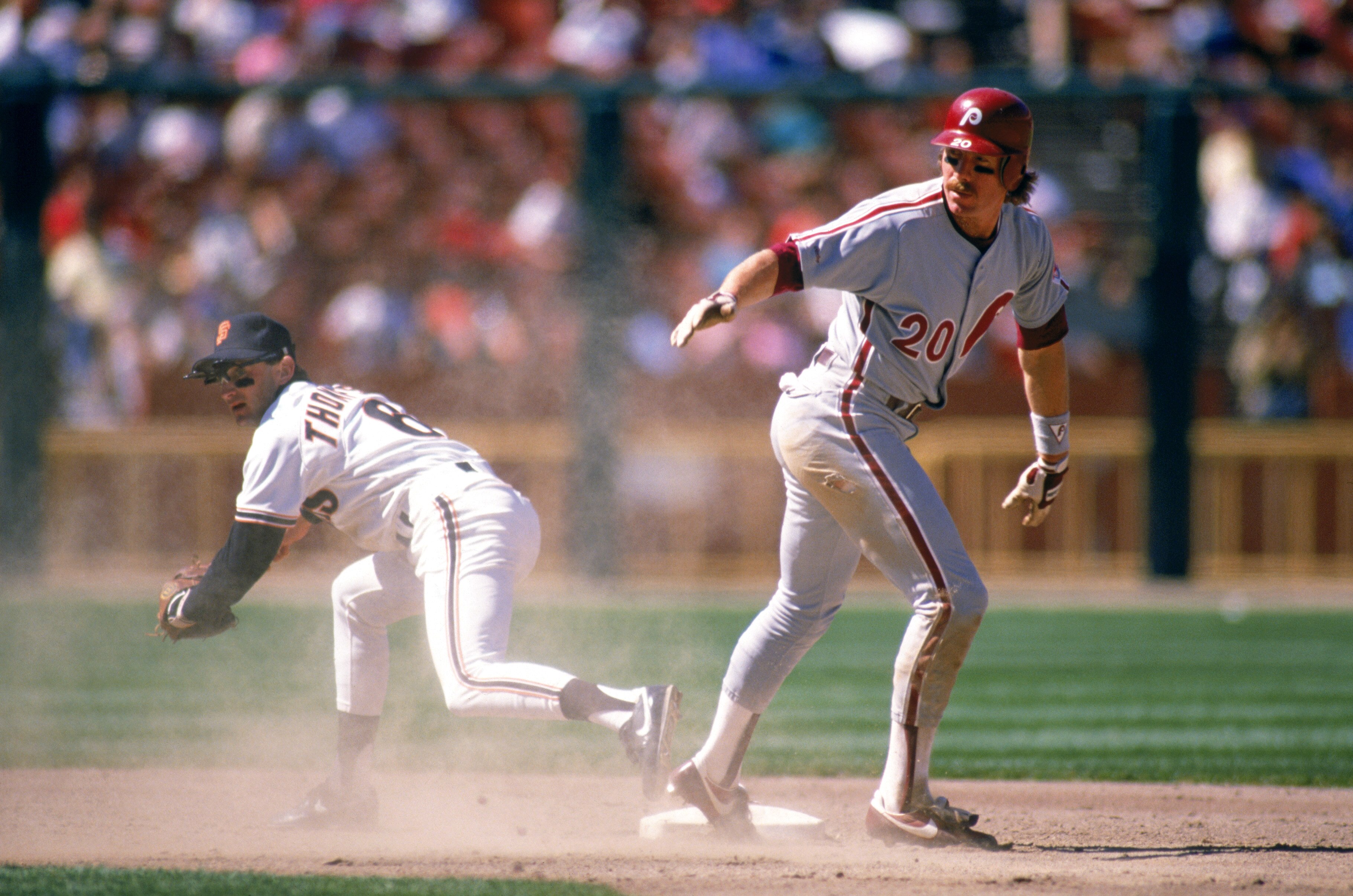 SAN FRANCISCO - 1989:  Mike Schmidt #20 of the Philadelphia Phillies stands on base after beating Robby Thompson #6 of the Giants during a 1989 season game at Candlestick Park in San Francisco, California. (Photo by Otto Greule Jr/Getty Images)