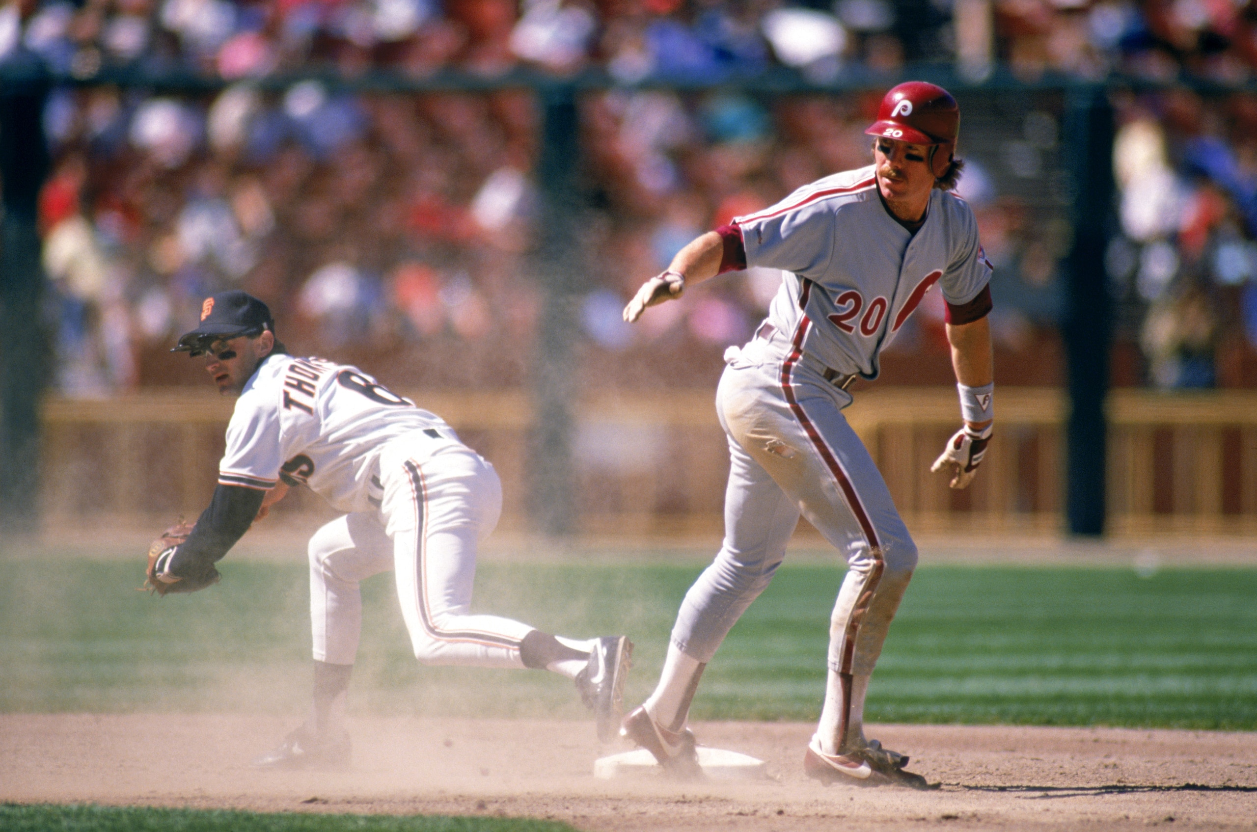 SAN FRANCISCO - 1989:  Mike Schmidt #20 of the Philadelphia Phillies stands on base after beating Robby Thompson #6 of the Giants during a 1989 season game at Candlestick Park in San Francisco, California. (Photo by Otto Greule Jr/Getty Images)