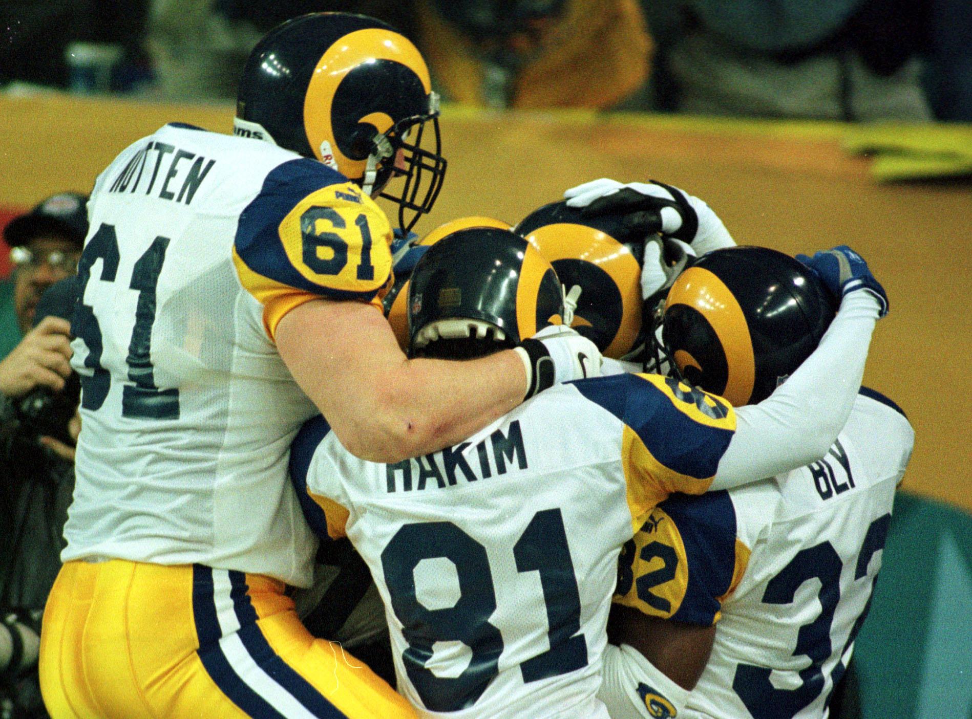 30 Jan 2000: Tom Nutten #61, Az-Zahir Hakim #81 And Dre Bly #32 Of The St Louis Rams Celebrate With Isaac Bruce #80 After His Game-Winning Touchdown In The Fourth Quarter Of Super Bowl Xxxiv Between The St Louis Rams And Tennessee Titans At The Georgia Do