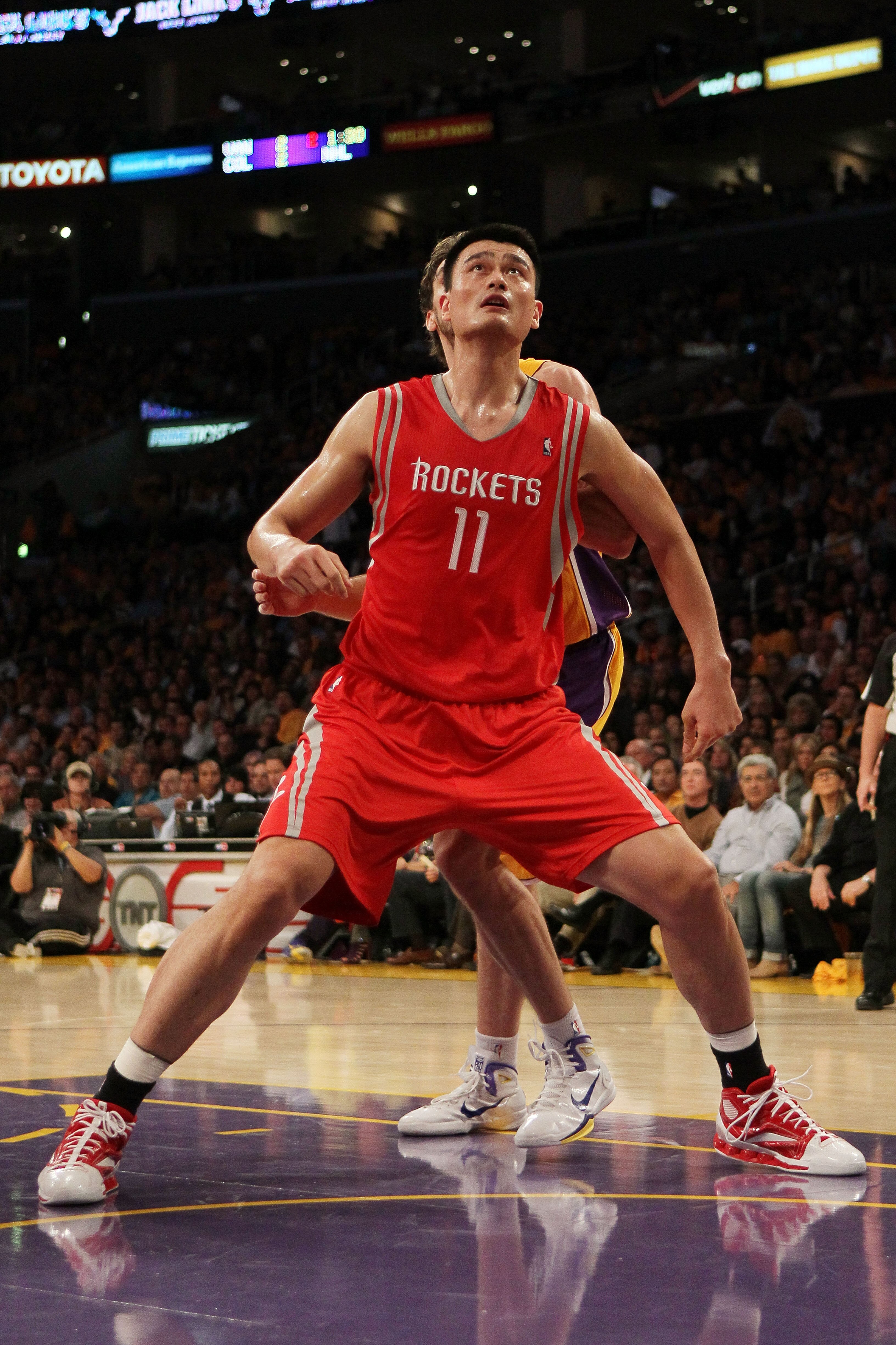 LOS ANGELES, CA - OCTOBER 26:  Yao Ming #11 of the Houston Rockets looks to rebound during their opening night game against the Los Angeles Lakers at Staples Center on October 26, 2010 in Los Angeles, California. NOTE TO USER: User expressly acknowledges