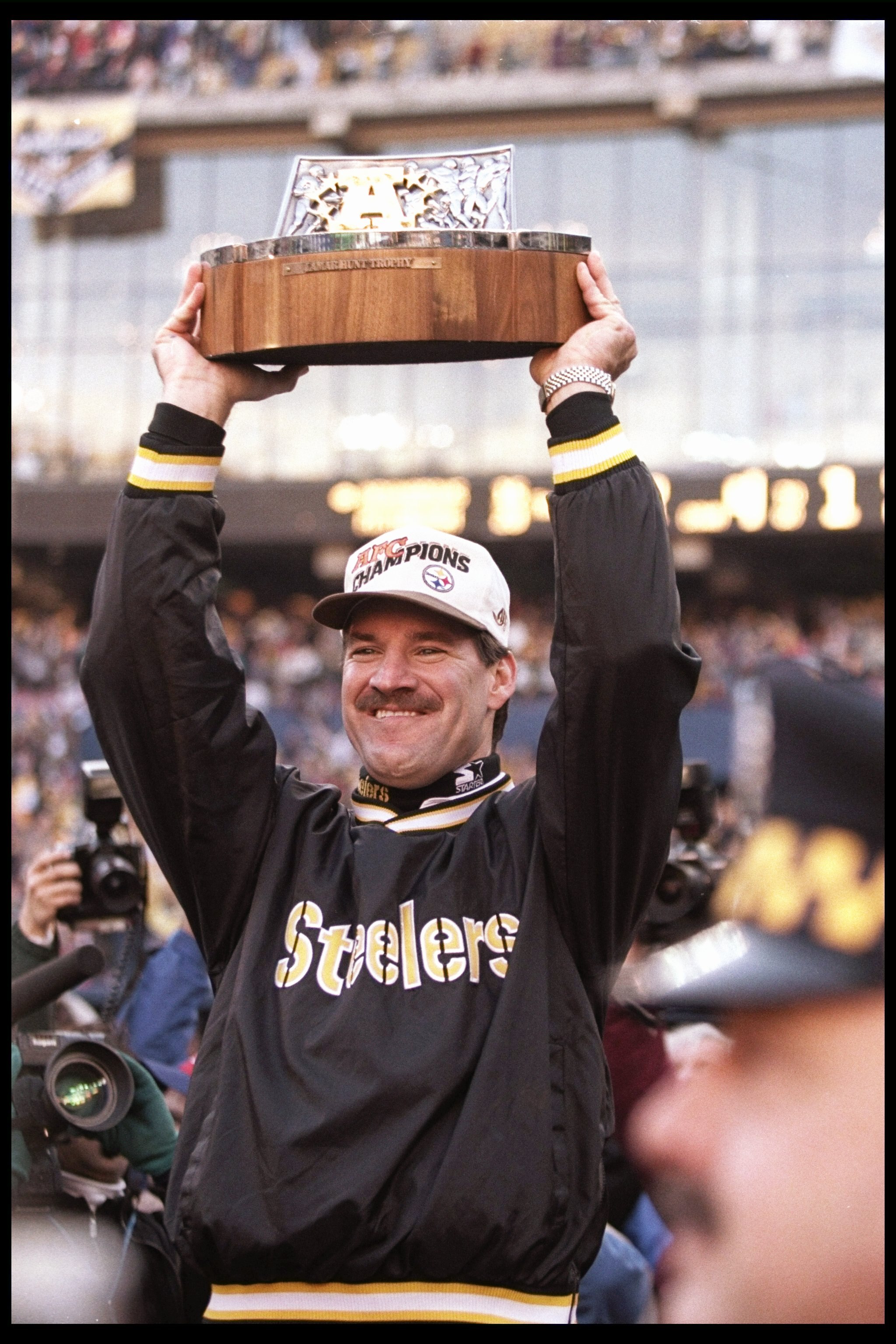 14 Jan 1996: Pittsburgh Steelers head coach Bill Cowher holds the trophy after a playoff game against the Indianapolis Colts at Three Rivers Stadium in Pittsburgh, Pennsylvania. The Steelers won the game, 20-16.