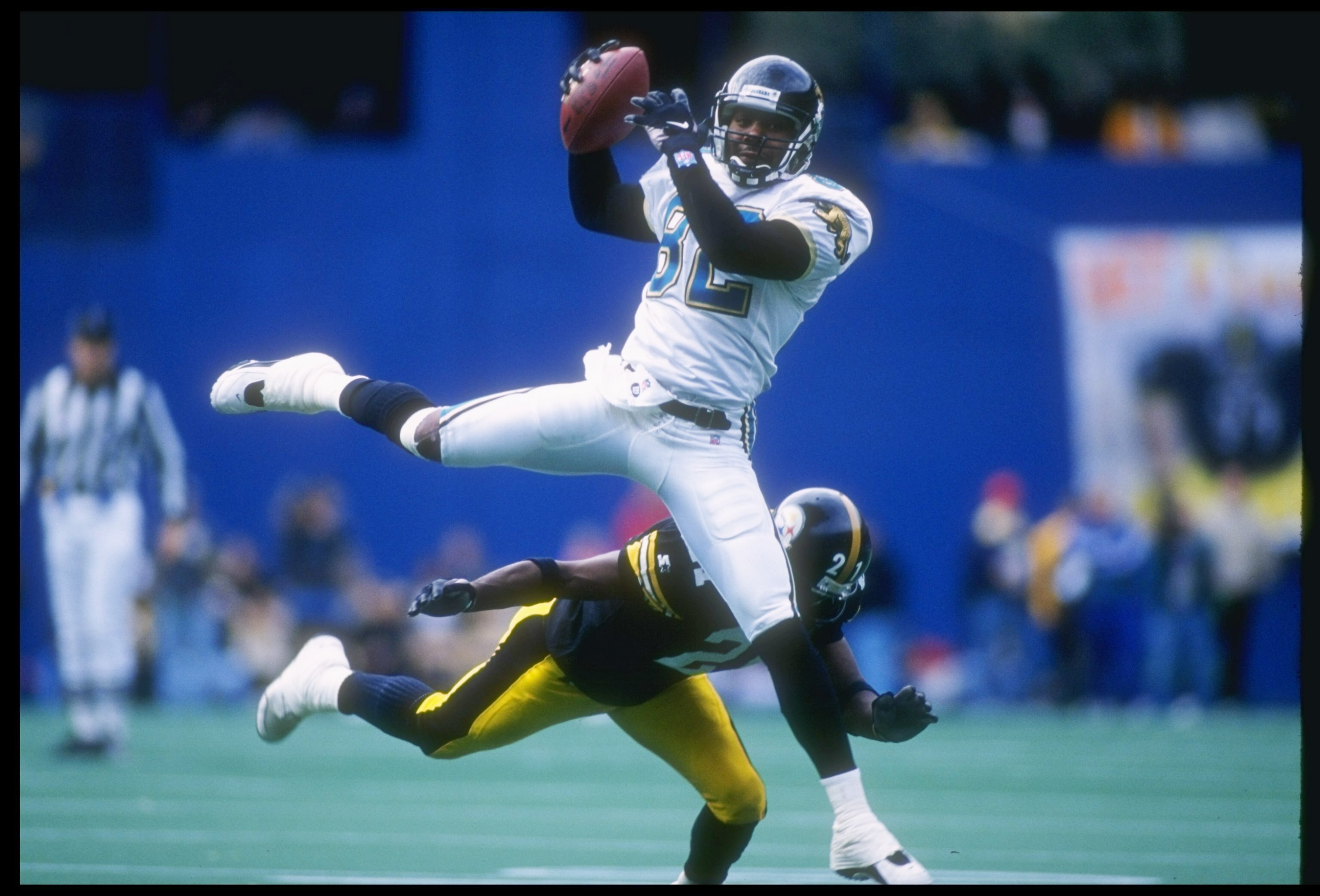17 Nov 1996:  Wide receiver Jimmy Smith of the Jacksonville Jaguars makes a catch as cornerback Deon Figures of the Pittsburgh Steelers falls down during a game at Three Rivers Stadium in Pittsburgh, Pennsylvania.  The Steelers won the game 28-3. Mandator