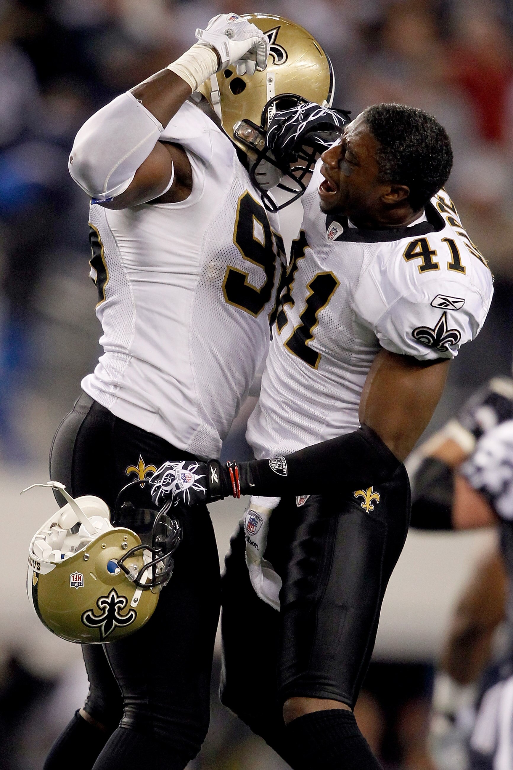 ARLINGTON, TX - NOVEMBER 25: Alex Brown #96 of the New Orleans Saints and Roman Harper #41 celebrate stopping the Dallas Cowboys in the final minute of the fourth quarter at Cowboys Stadium on November 25, 2010 in Arlington, Texas.  (Photo by Matthew Stoc