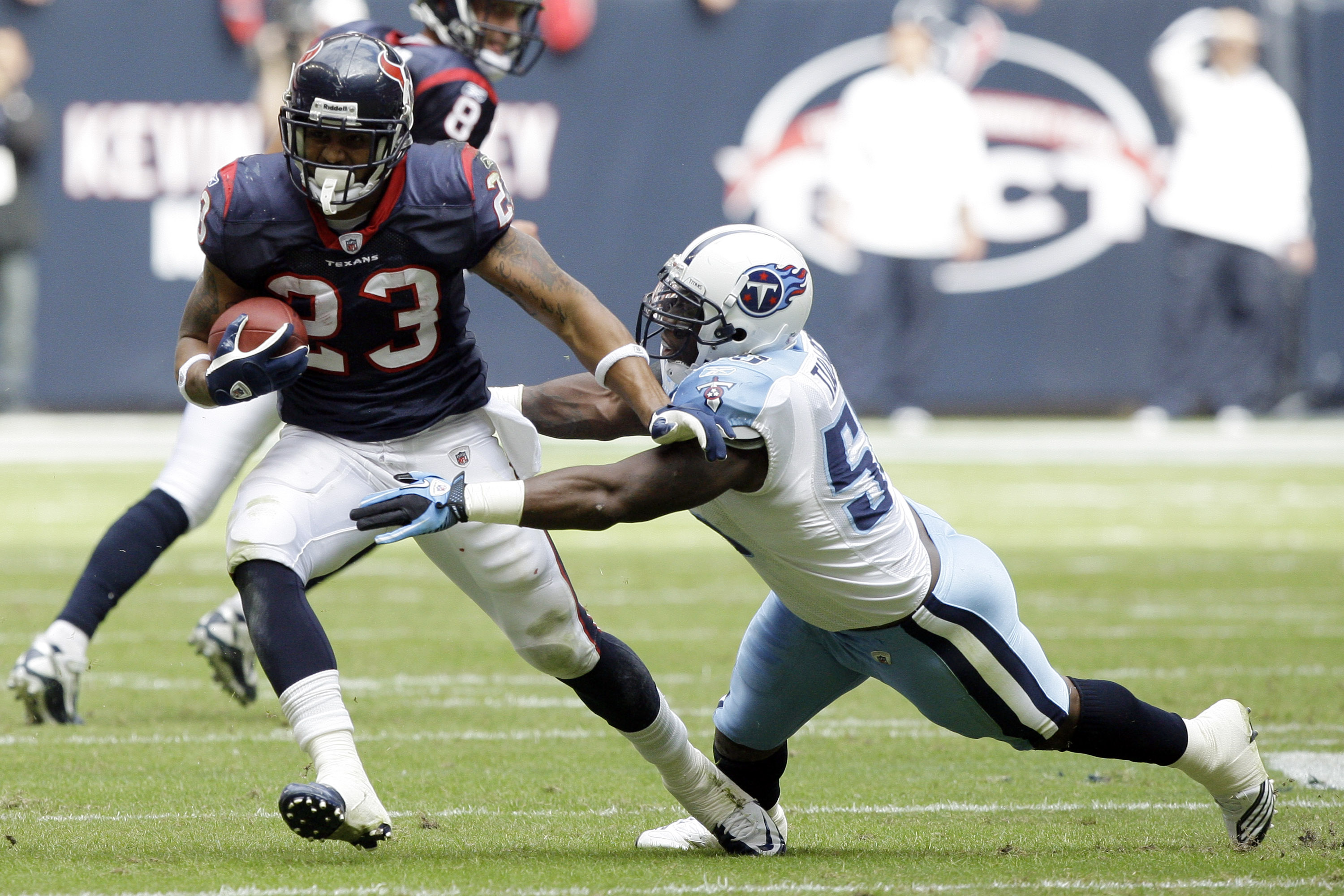 HOUSTON - NOVEMBER 28:  Running back Arian Foster #23 of the Houston Texans avoids a tackle from linebacker Stephen Tulloch #55 of the Tennessee Tians at Reliant Stadium on November 28, 2010 in Houston, Texas.  (Photo by Bob Levey/Getty Images)