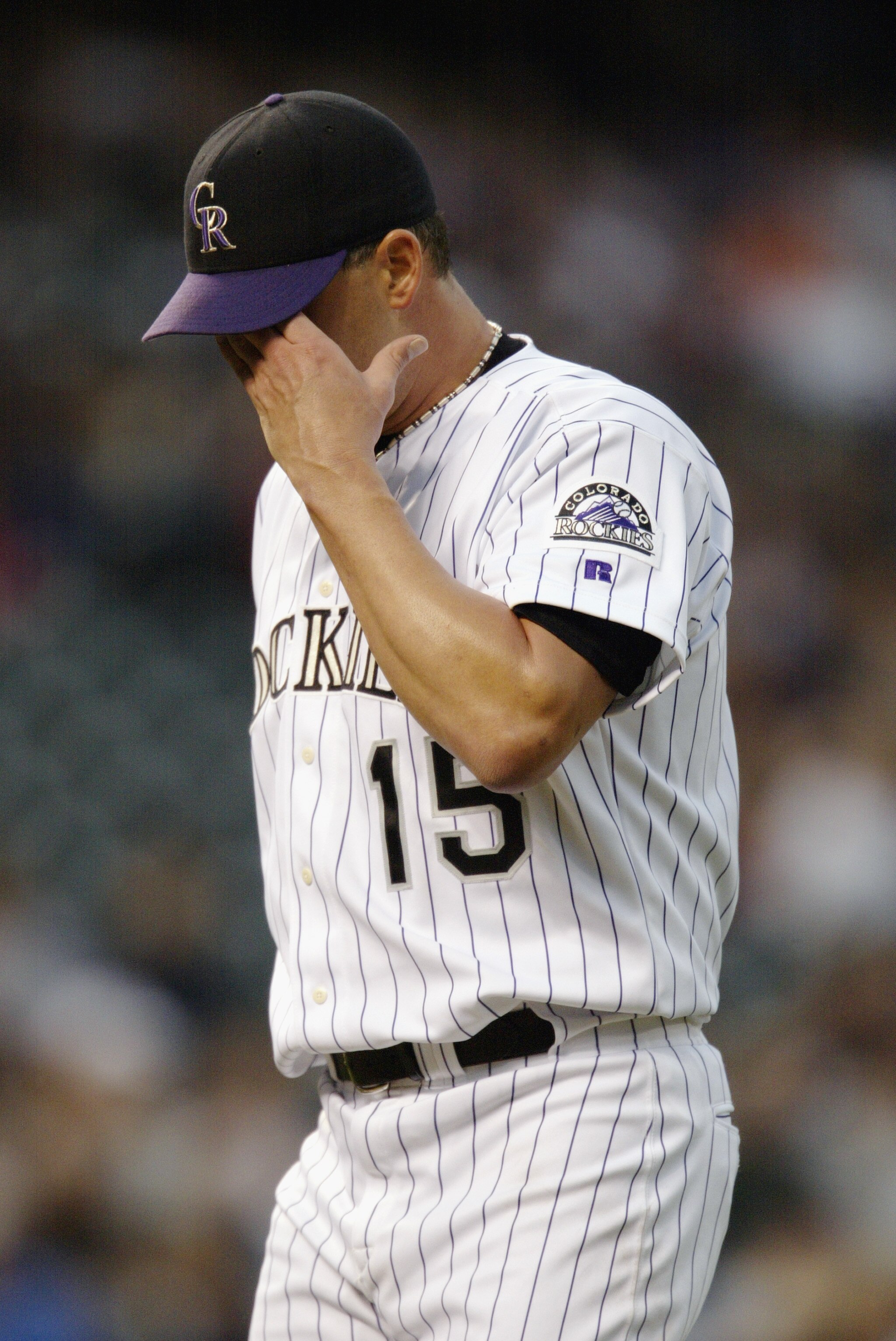 DENVER - JUNE 17:  Starting pitcher Denny Neagle #15 of the Colorado Rockies wipes his brow as he walks to the dugout after giving up a home run to first baseman Ryan Klesko #30 of the San Diego Padres in the second inning of the game at Coors Field on Ju