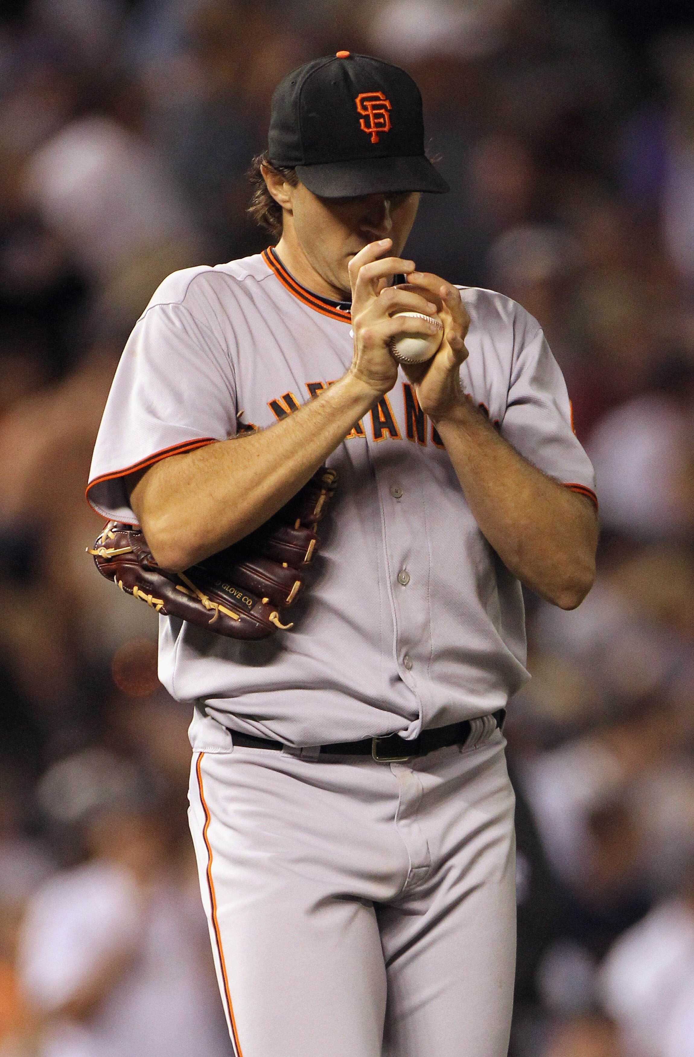 DENVER - SEPTEMBER 25:  Starting pitcher Barry Zito #75 of the San Francisco Giants pauses as manager Bruce Bochy heads to the mound to remove him in the fifth inning against the Colorado Rockies at Coors Field on September 25, 2010 in Denver, Colorado.