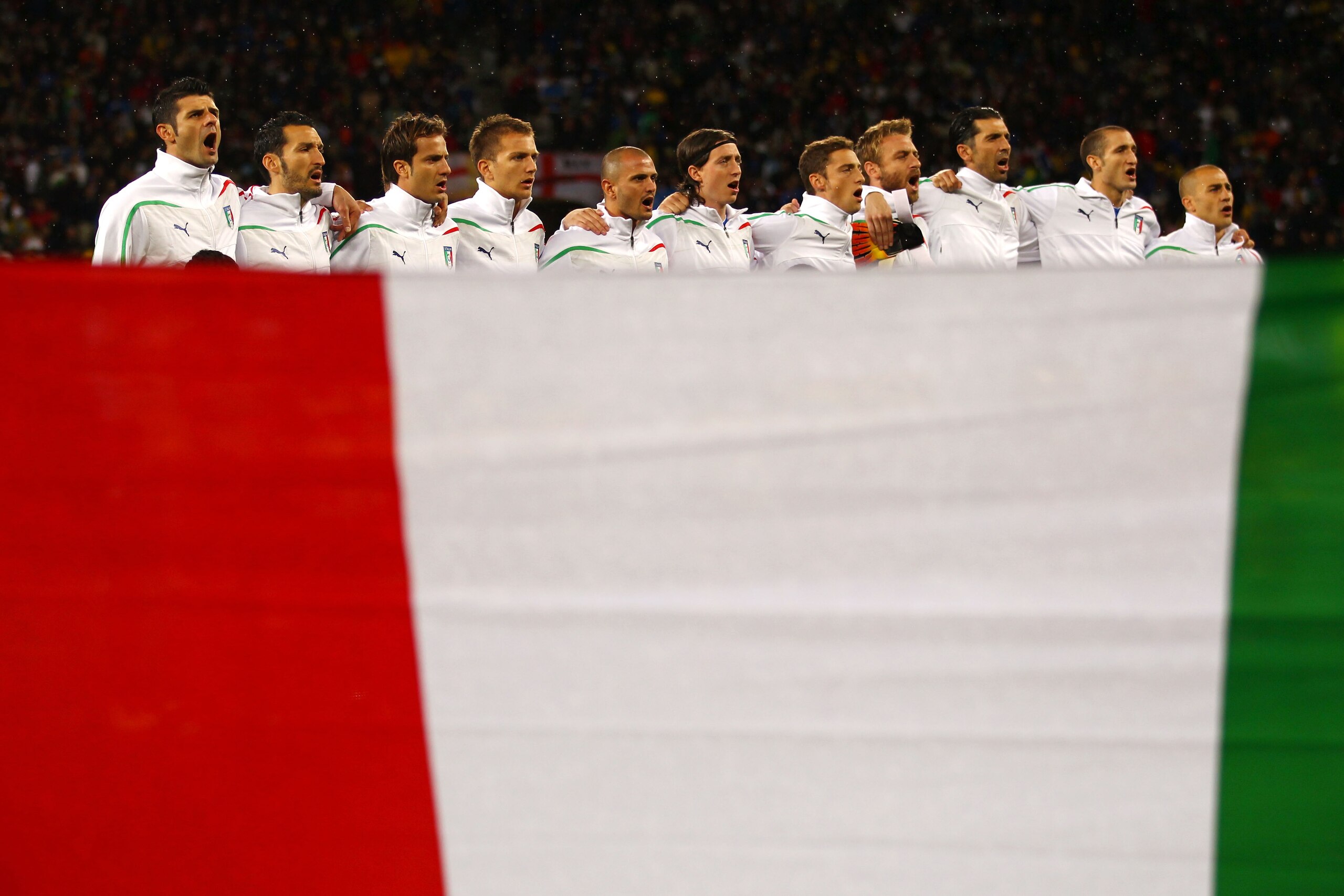 CAPE TOWN, SOUTH AFRICA - JUNE 14: The Italy team sing the national anthem prior to the 2010 FIFA World Cup South Africa Group F match between Italy and Paraguay at Green Point Stadium on June 14, 2010 in Cape Town, South Africa.  (Photo by Lars Baron/Get