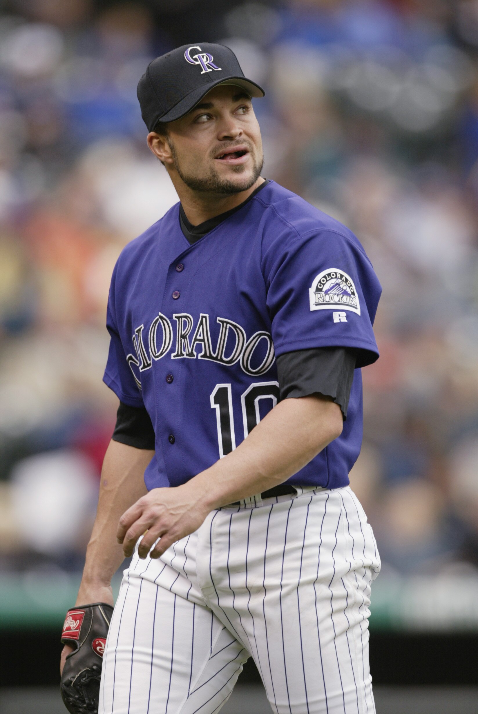 DENVER - May 16 2002:   Starting pitcher Mike Hampton #10 of the Colorado Rockies smiles as he walks off the field after retiring the Florida Marlins in the third inning at Coors Field in Denver, Colorado, on May 16, 2002.   Hampton got the 10-3 win on th