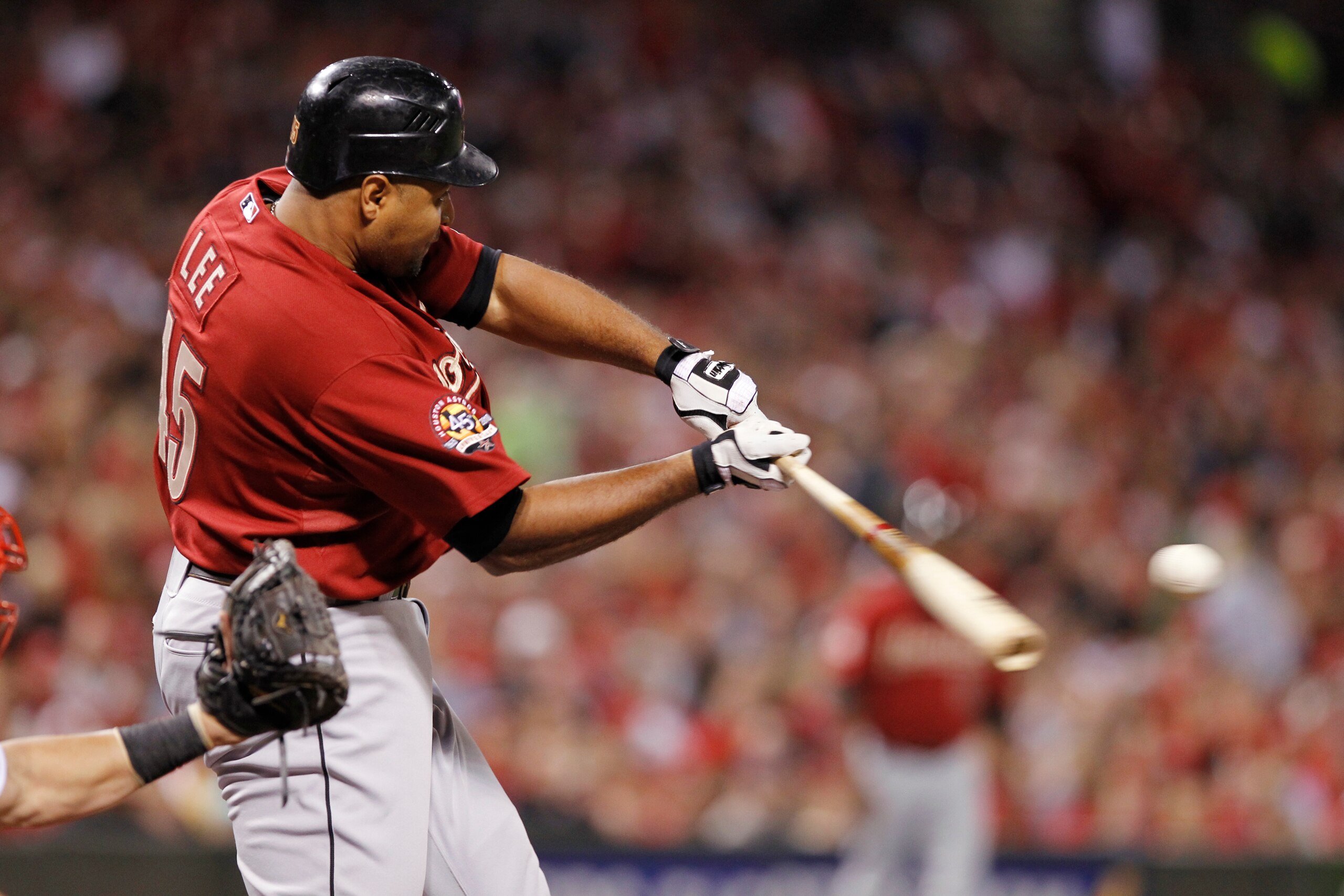 CINCINNATI, OH - SEPTEMBER 28: Carlos Lee #45 of the Houston Astros hits a ball that would have been a home run but was caught above the outfield wall by Drew Stubbs of the Cincinnati Reds at Great American Ball Park on September 28, 2010 in Cincinnati, O