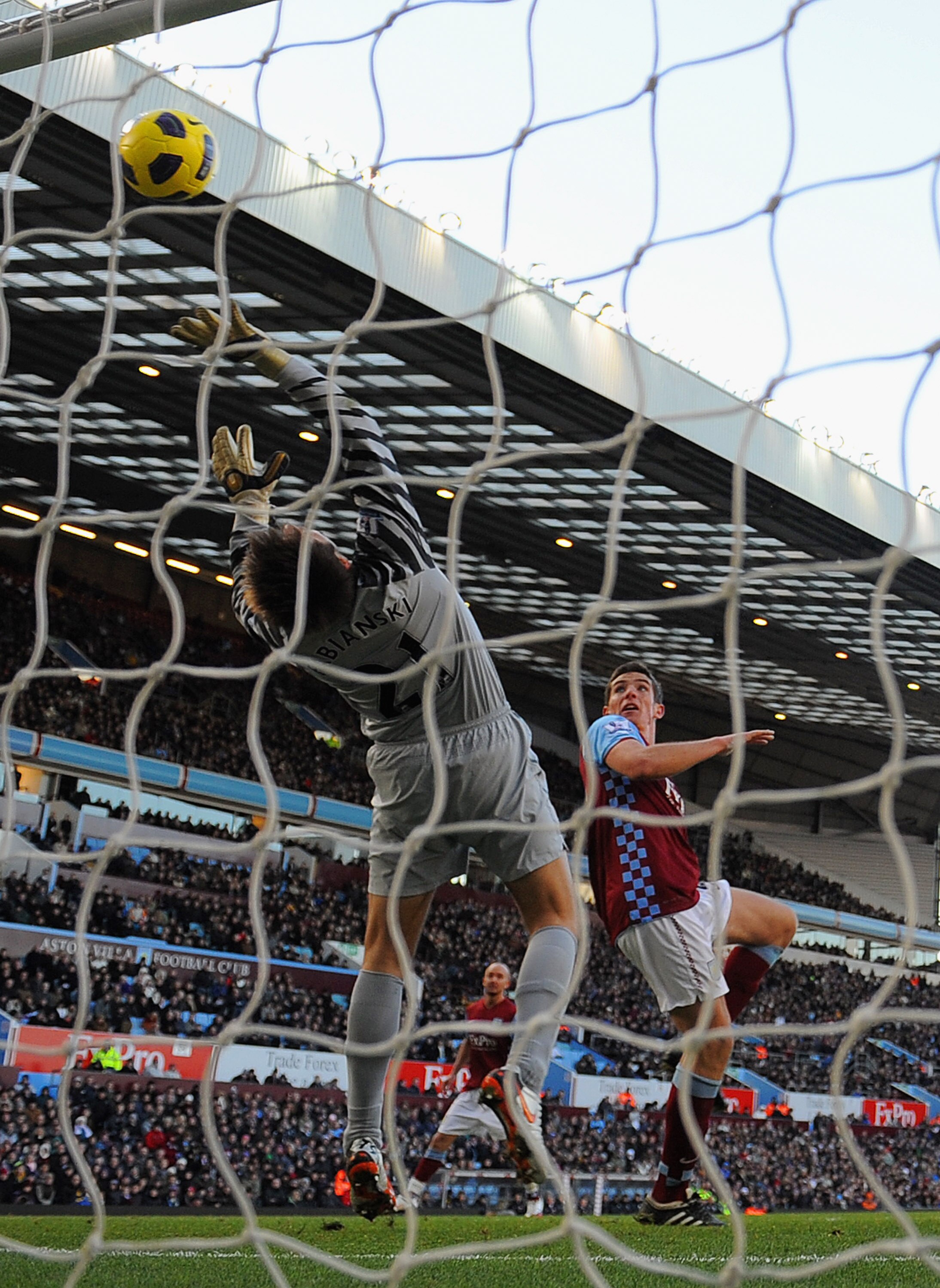 BIRMINGHAM, ENGLAND - NOVEMBER 27:  Ciaran Clark of Villa beats Lukasz Fabianski of Arsenal to score to make it 3-2 during the Barclays Premier League match between Aston Villa and Arsenal at Villa Park on November 27, 2010 in Birmingham, England.  (Photo