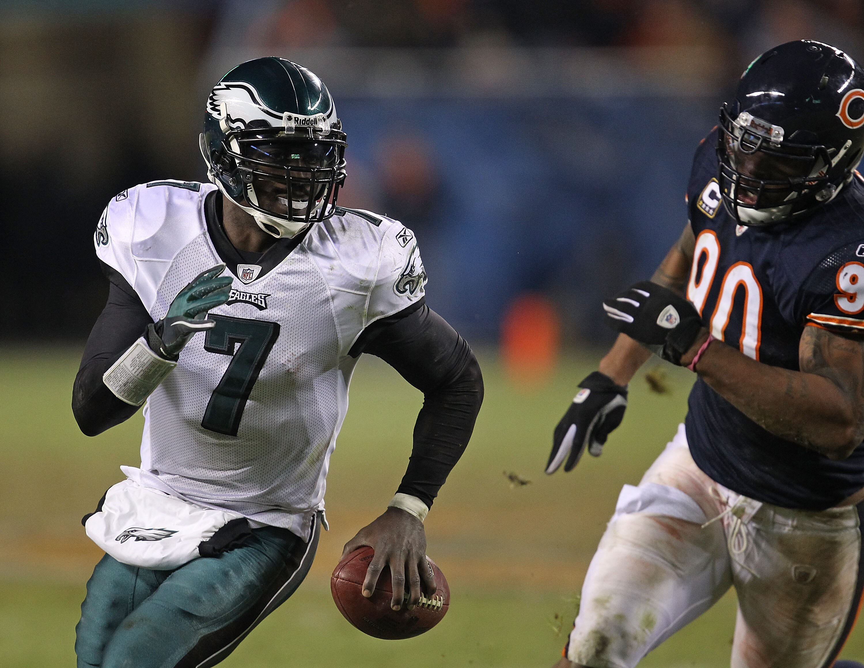CHICAGO - NOVEMBER 28: Michael Vick #7 of the Philadelphia Eagles runs to avoid Julius Peppers #90 of the Chicago Bears at Soldier Field on November 28, 2010 in Chicago, Illinois. The Bears defeated the Eagles 31-26. (Photo by Jonathan Daniel/Getty Images