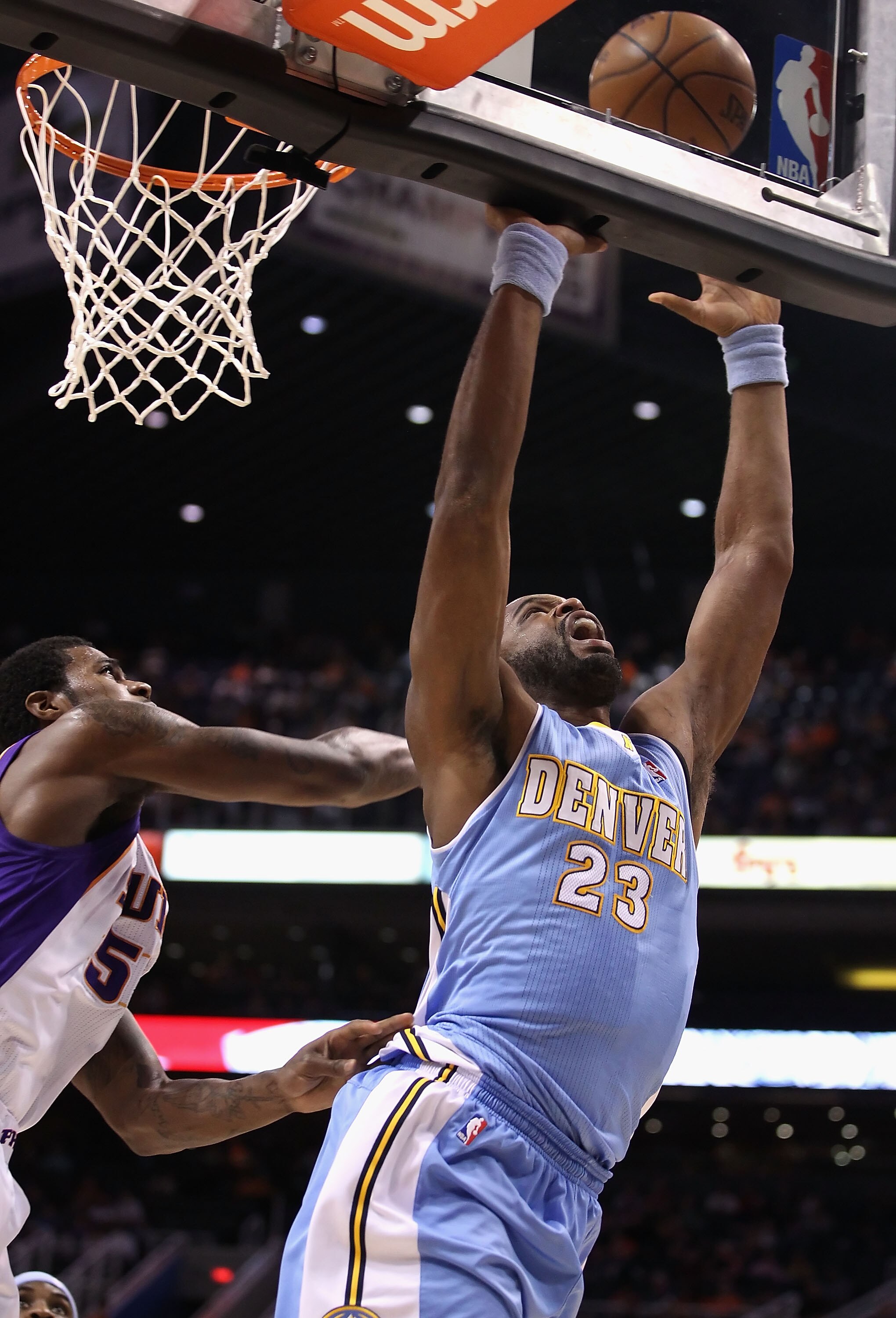 PHOENIX - OCTOBER 22:  Shelden Williams #23 of the Denver Nuggets grabs a rebound against the Phoenix Suns during the preseason NBA game at US Airways Center on October 22, 2010 in Phoenix, Arizona. NOTE TO USER: User expressly acknowledges and agrees tha