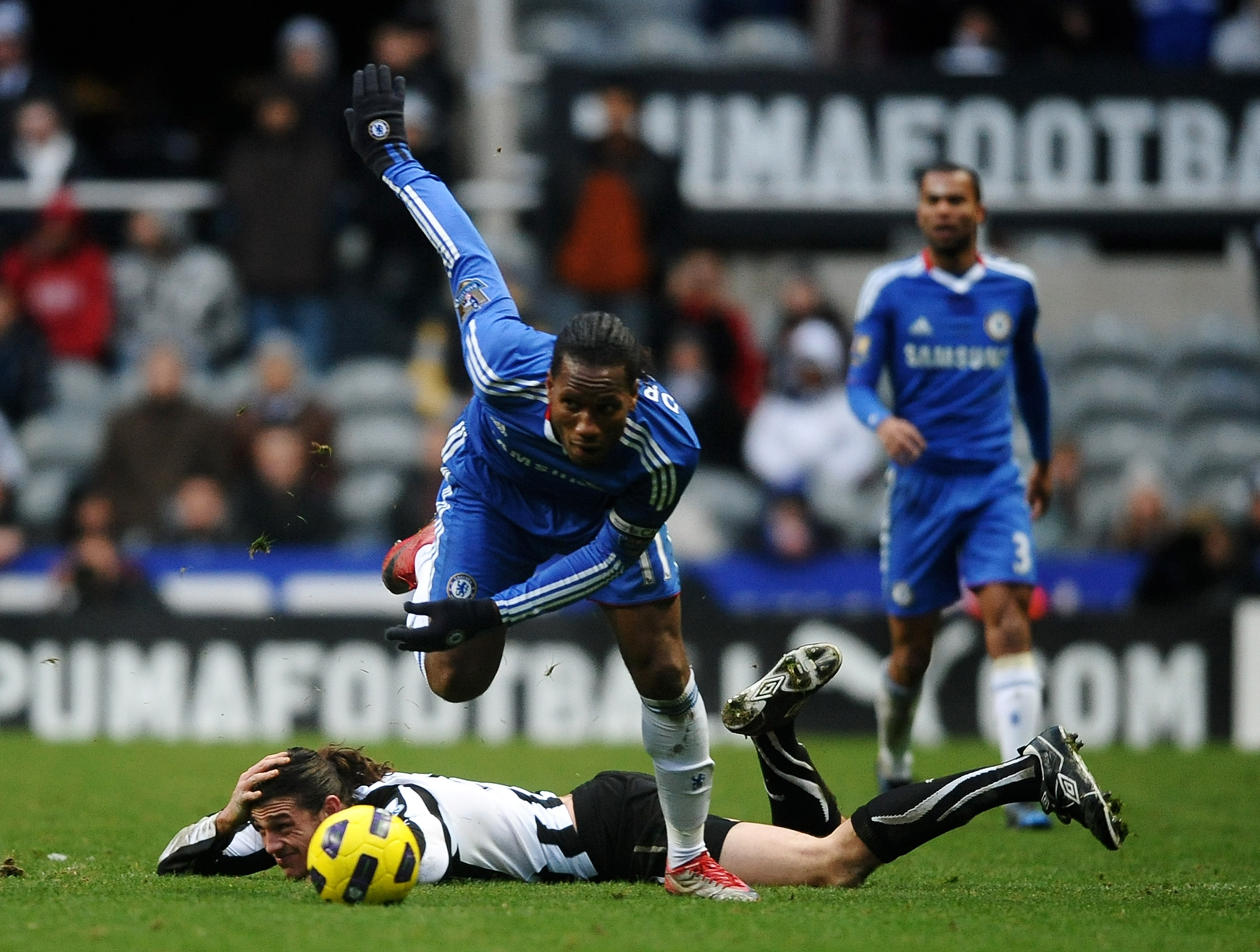 NEWCASTLE UPON TYNE, ENGLAND - NOVEMBER 28:  Didier Drogba of Chelsea hurdles Andy Carroll of Newcastle United during the Barclays Premier League match between Newcastle United and Chelsea at St James' Park on November 28, 2010 in Newcastle, England.  (Ph