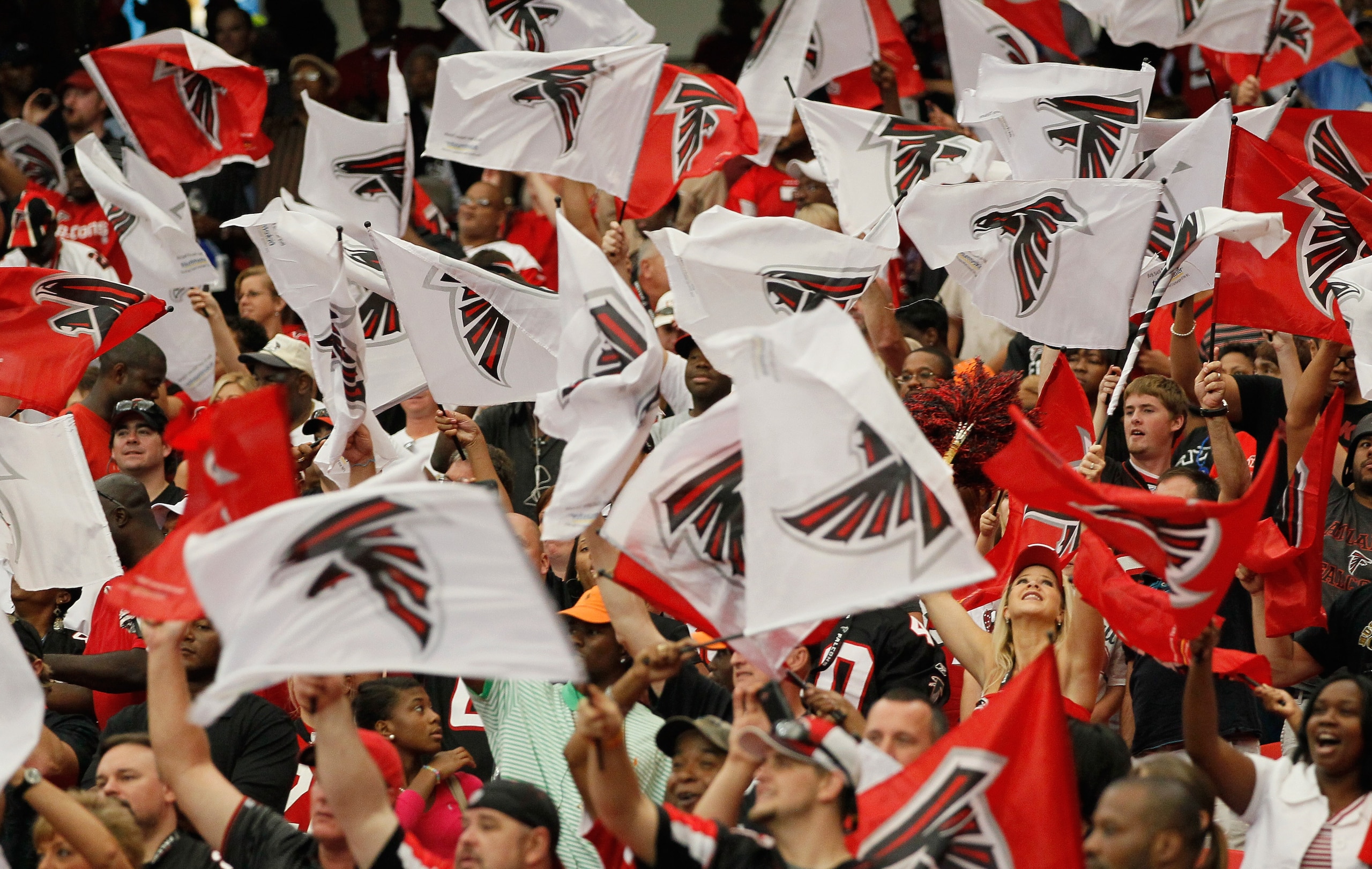 ATLANTA - SEPTEMBER 19:  Fans of the Atlanta Falcons wave flags during the game against the Arizona Cardinals at Georgia Dome on September 19, 2010 in Atlanta, Georgia.  (Photo by Kevin C. Cox/Getty Images)