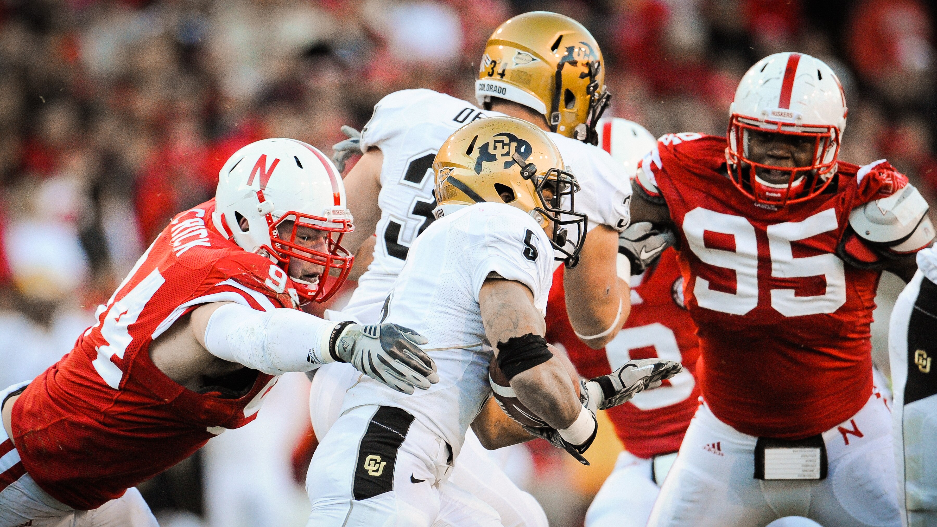 LINCOLN, NE - NOVEMBER 26: Jared Crick #94 and Pierre Allen #95 of the Nebraska Cornhuskers zero in on for Rodney Stewart #5 of the Colorado Buffaloes during their game at Memorial Stadium on November 26, 2010 in Lincoln, Nebraska. Nebraska defeated Color