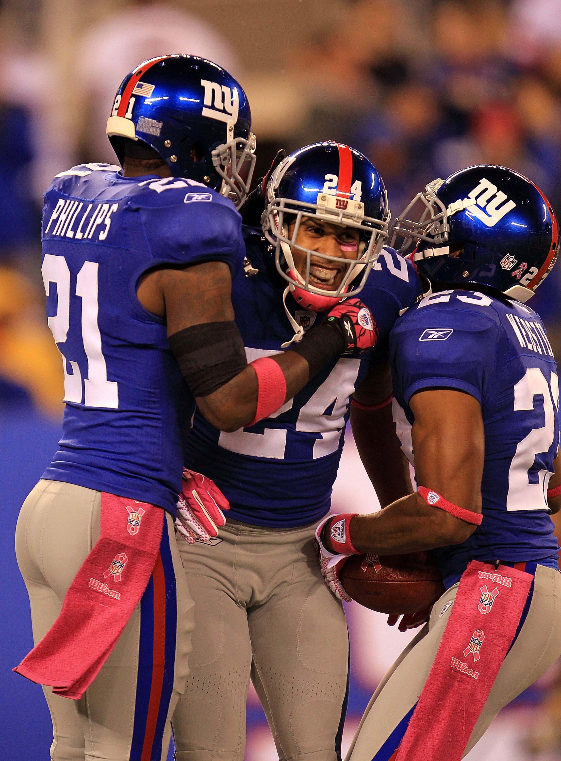 EAST RUTHERFORD, NJ - OCTOBER 03:  Terrell Thomas #24 of the New York Giants celebrates after an interception against the Chicago Bears with teammates Kenny Phillips #21 and Corey Webster #23 at New Meadowlands Stadium on October 3, 2010 in East Rutherfor