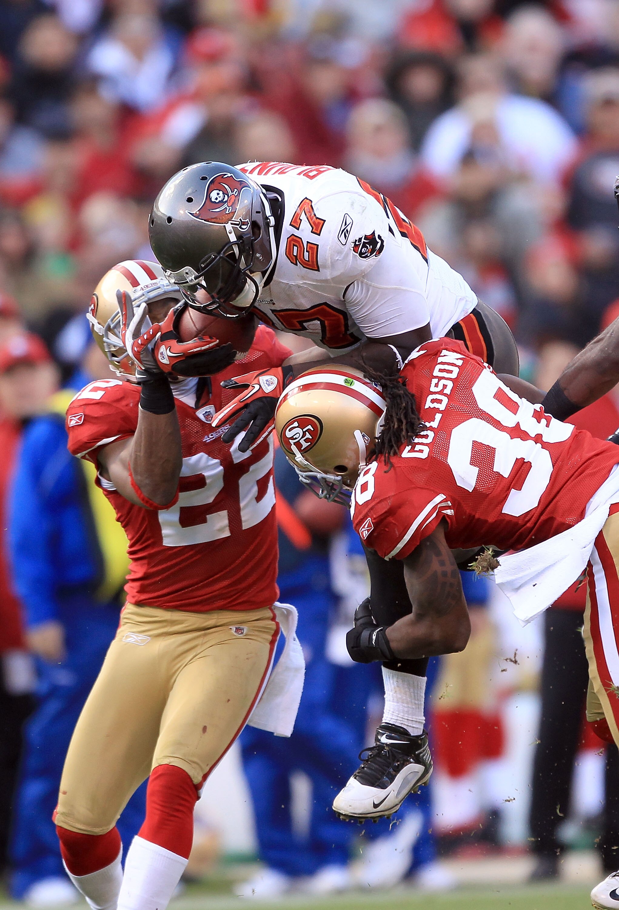 SAN FRANCISCO - NOVEMBER 21:  LeGarrette Blount #27 of the Tampa Bay Buccaneers is hit by Dashon Goldson #38 and Nate Clements #22 of the San Francisco 49ers at Candlestick Park on November 21, 2010 in San Francisco, California.  (Photo by Ezra Shaw/Getty