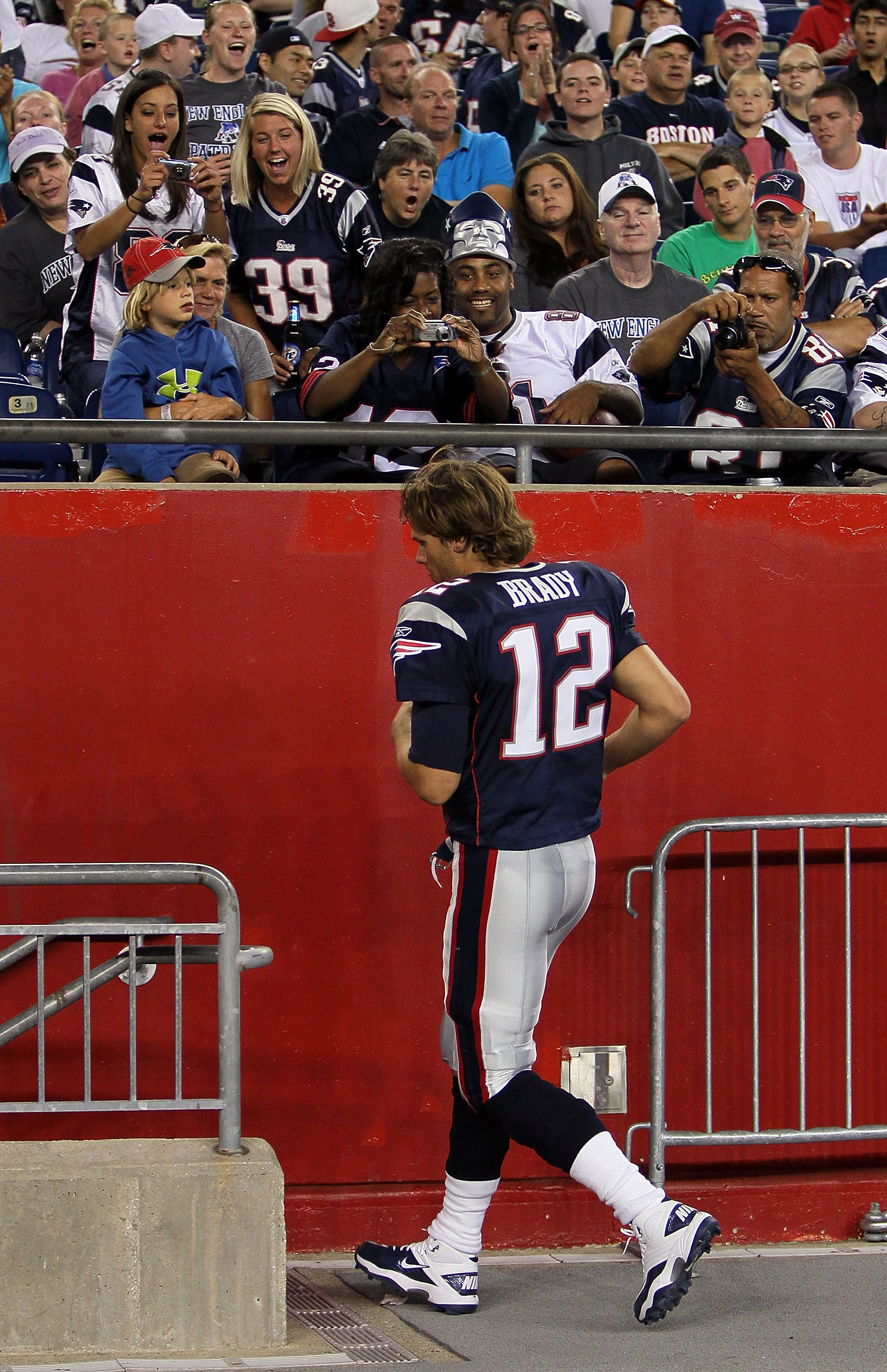 FOXBORO, MA - AUGUST 12: Fans cheer as Tom Brady # 12 of the New England Patriots leaves the field in the final minutes of a 27 - 24 win over the New Orleans Saints in a preseason game at Gillette Stadium on August 12, 2010 in Foxboro, Massachusetts. (Pho