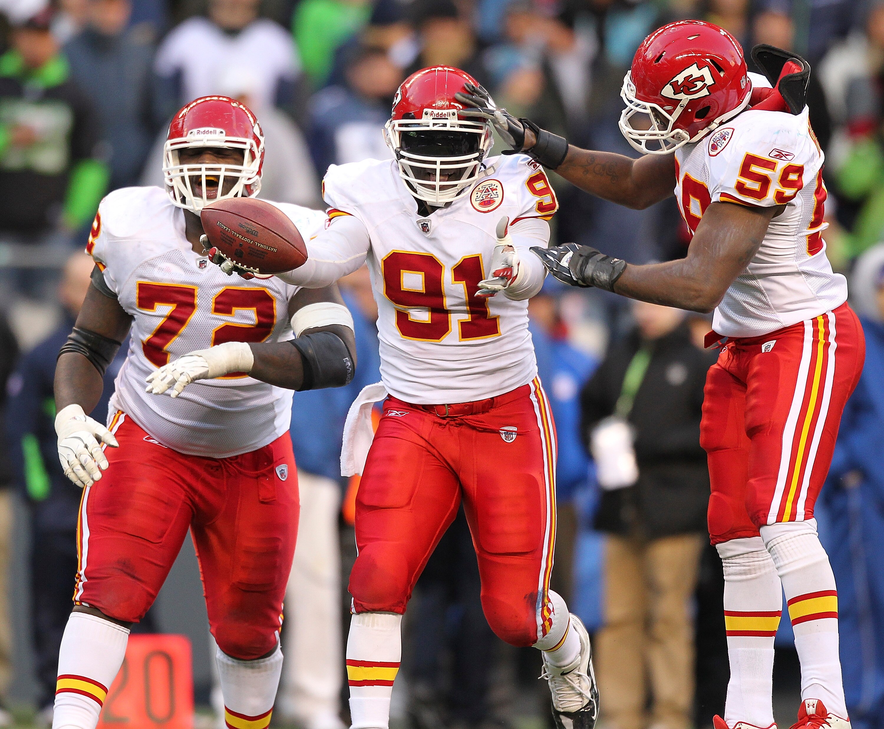 SEATTLE - NOVEMBER 28:  Linebacker Tamba Hali #91 of the Kansas City Chiefs celebrates with Glenn Dorsey #72 and Jovan Belcher #59 after recovering a fumble on a sack of quarterback Matt Hasselbeck of the Seattle Seahawks at Qwest Field on November 28, 20
