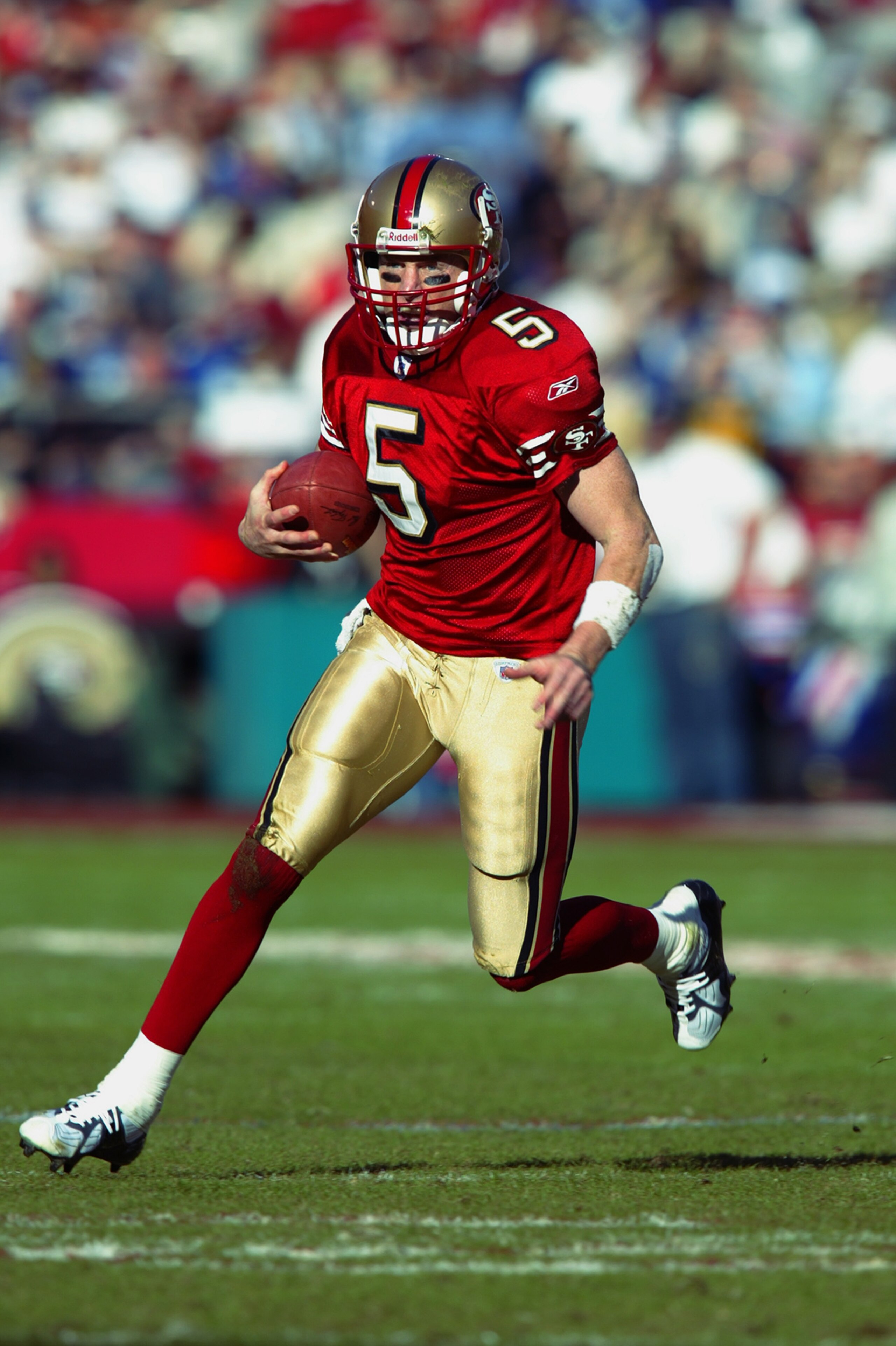 SAN FRANCISCO - JANUARY 5:  Quarterback Jeff Garcia  #5 of the San Fransisco 49ers scrambles for a gain against the New York Giants during the NFC Wild Card game at 3Com Park on January 5, 2003 in San Francisco, California.  The 49ers' rally was the bigge