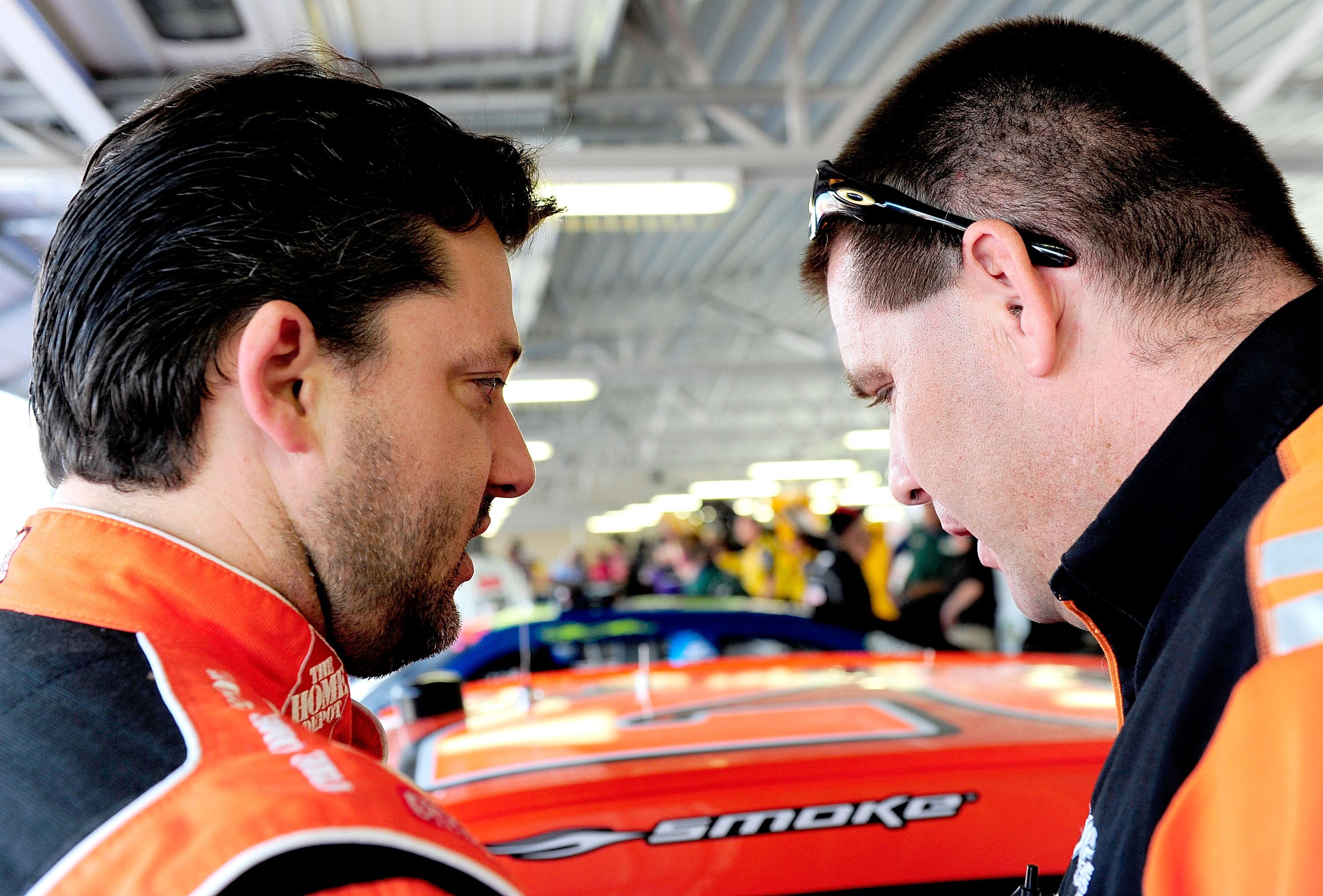 KANSAS CITY, KS - SEPTEMBER 27:  Tony Stewart (L), driver of the #20 Home Depot Toyota, talks with car chief Jason Shapiro (R) during practice for the NASCAR Sprint Cup Series Camping World RV 400 at Kansas Speedway on September 27, 2008 in Kansas City, K