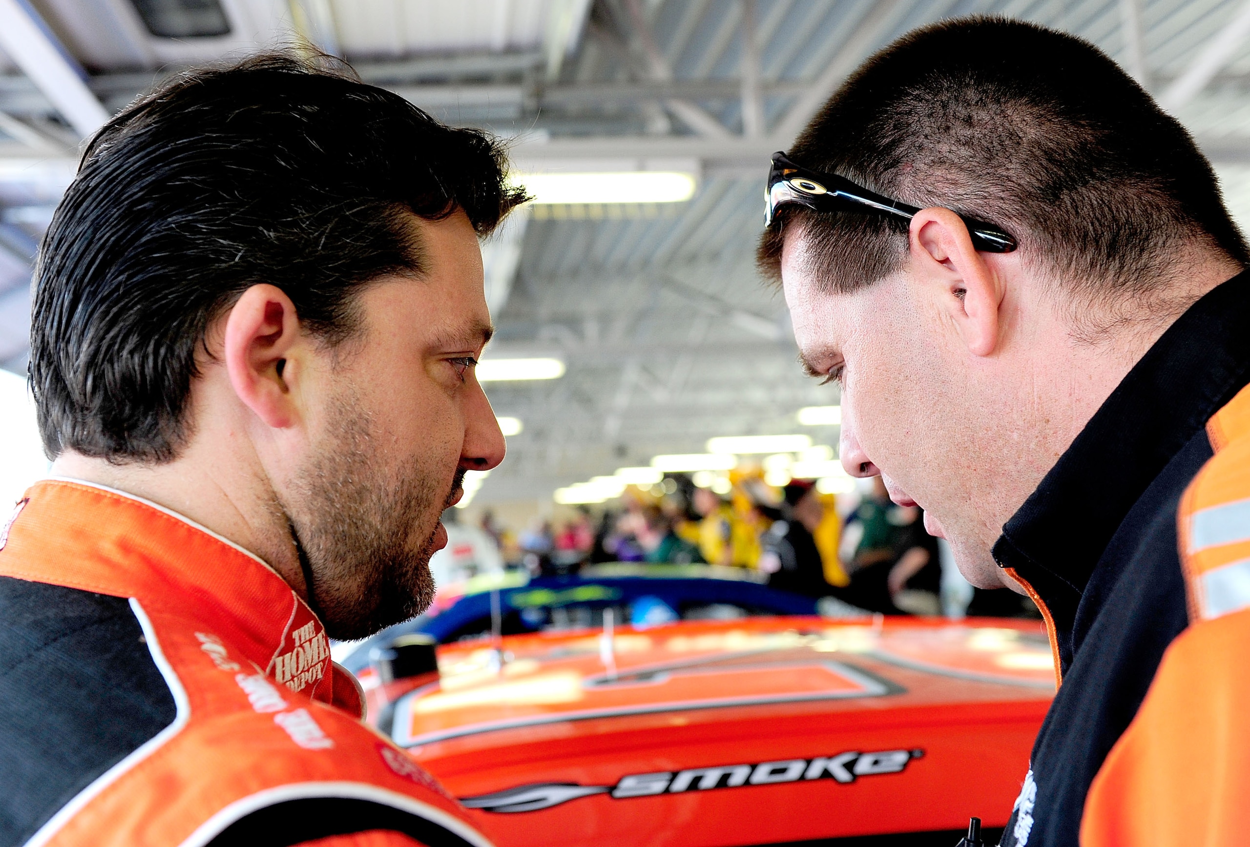 KANSAS CITY, KS - SEPTEMBER 27:  Tony Stewart (L), driver of the #20 Home Depot Toyota, talks with car chief Jason Shapiro (R) during practice for the NASCAR Sprint Cup Series Camping World RV 400 at Kansas Speedway on September 27, 2008 in Kansas City, K