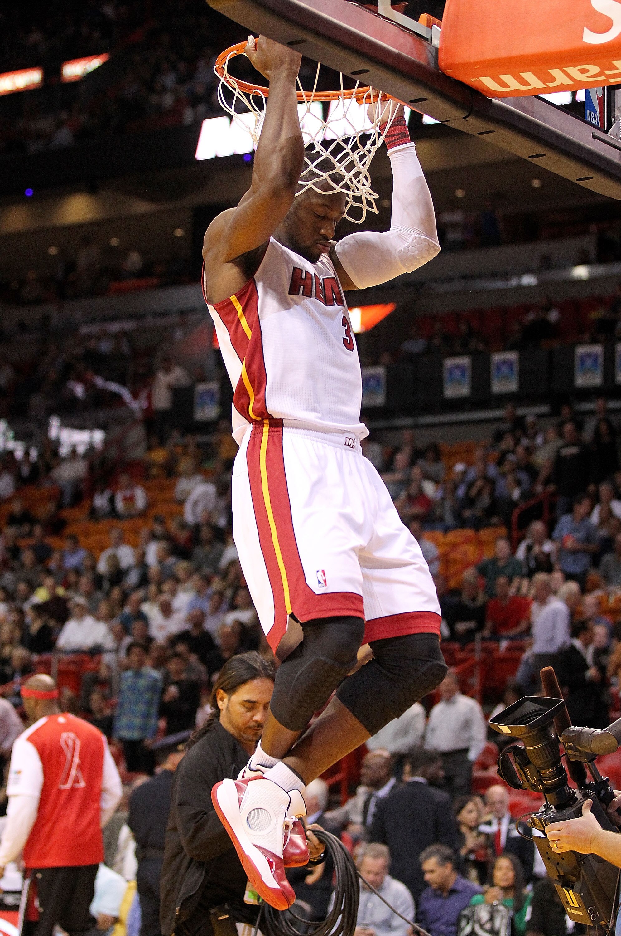 MIAMI, FL - DECEMBER 01: Dwyane Wade #3 of the Miami Heat does pull-ups on the basket during a game against the Detroit Pistons at American Airlines Arena on December 1, 2010 in Miami, Florida. NOTE TO USER: User expressly acknowledges and agrees that, by