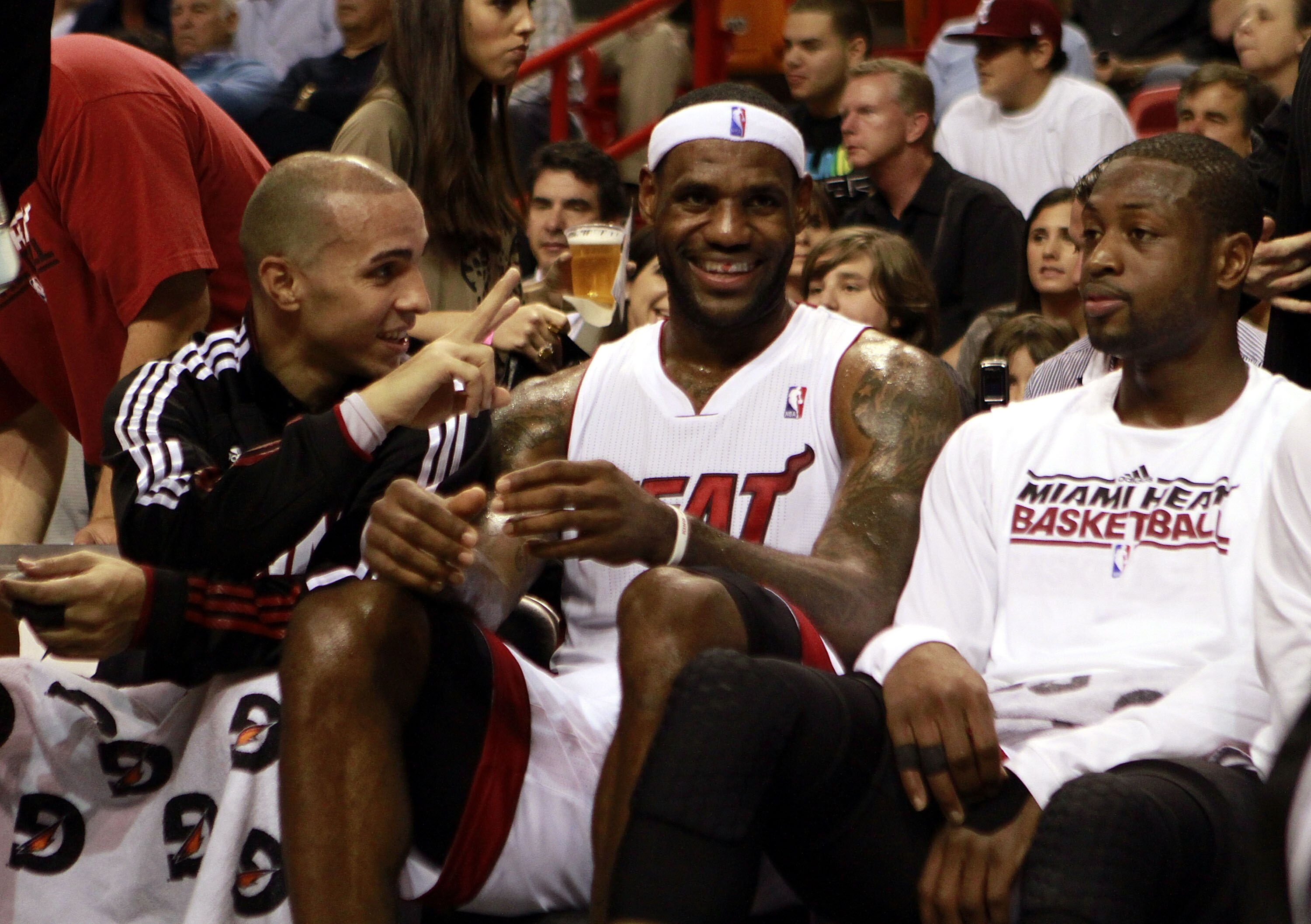 MIAMI - NOVEMBER 26:  Guard Dwyane Wade #3 (R)  Carlos Arroyo (L) #8 and LeBron James #6 of the Miami Heat sit on the bench during a game against the Philadelphia 76ers at American Airlines Arena on November 26, 2010 in Miami, Florida.  (Photo by Marc Ser