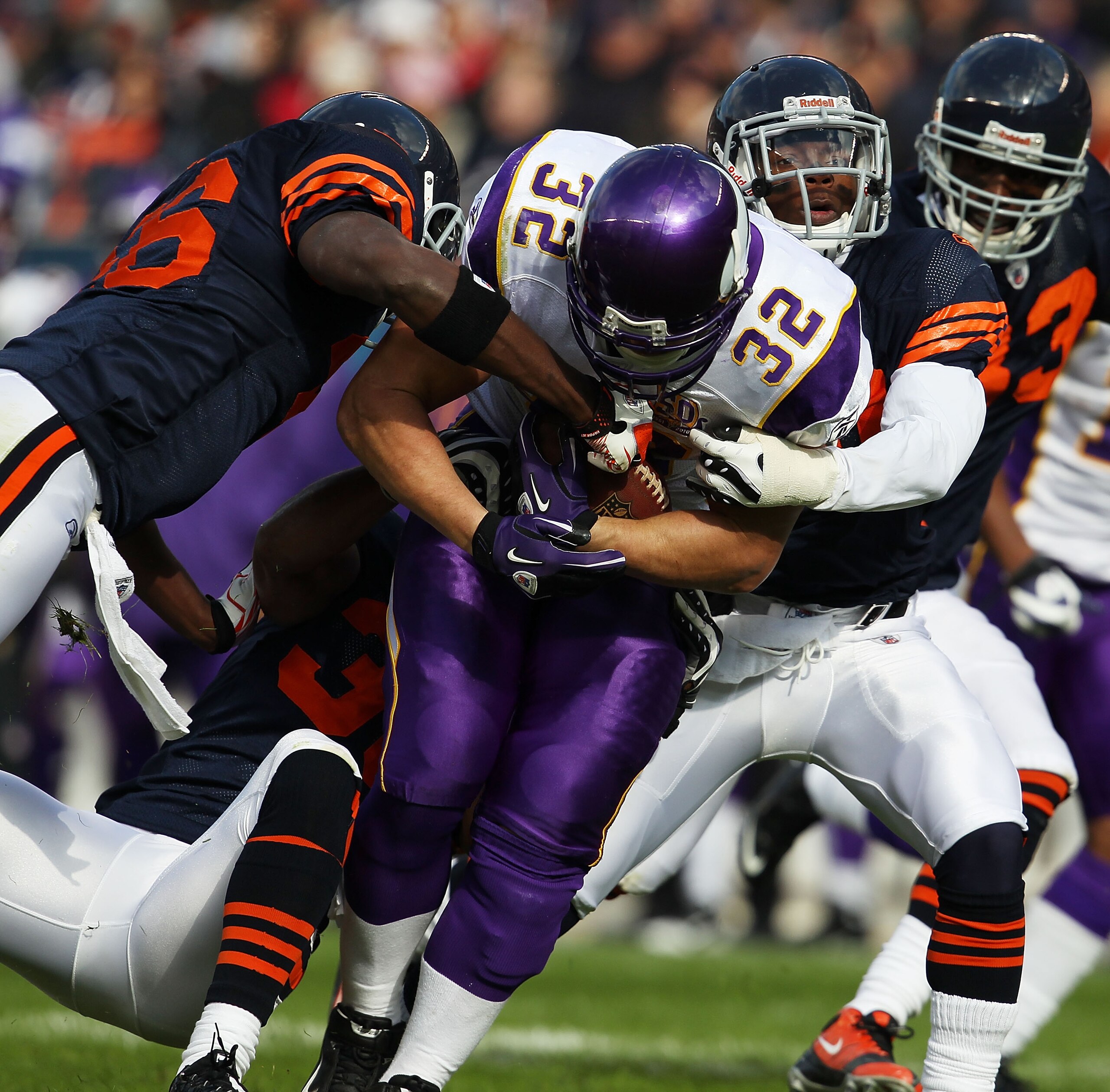 CHICAGO - NOVEMBER 14: Toby Gerhart #32 of the Minnesota Vikings is tackled by (L-R) Tim Jennings #26, Danieal Manning #38 and Chris Harris #46 of the Chicago Bears at Soldier Field on November 14, 2010 in Chicago, Illinois. The Bears defeated the Vikings
