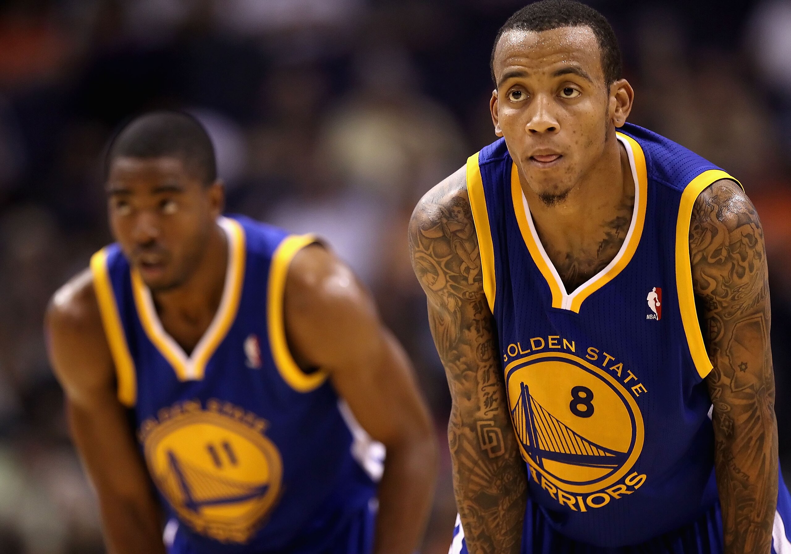 PHOENIX - OCTOBER 19:  Monta Ellis #8 (R) and Aaron Miles #11 of the Golden State Warriors await a free throw shot against the Phoenix Suns during the preseason NBA game at US Airways Center on October 19, 2010 in Phoenix, Arizona. NOTE TO USER: User expr