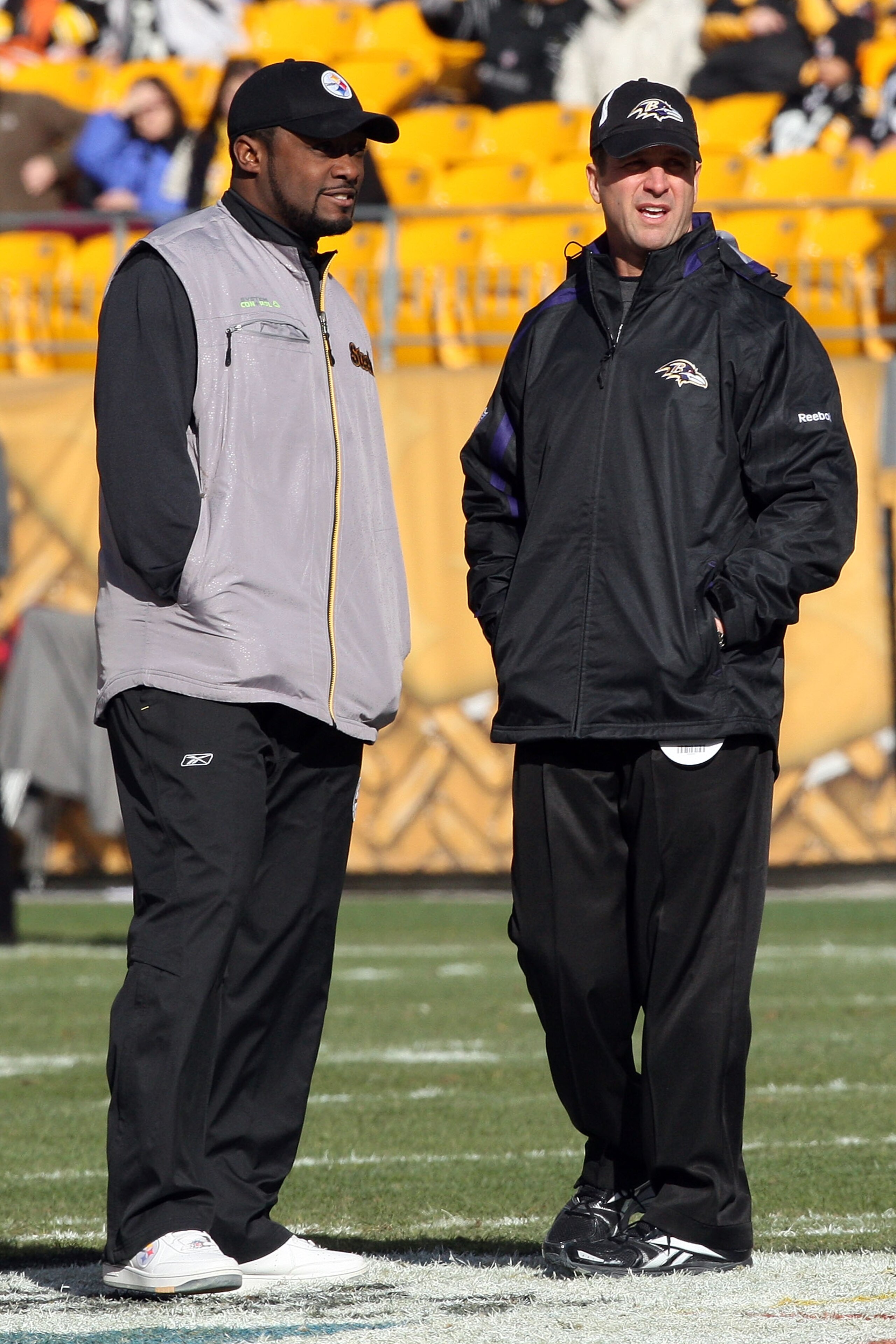PITTSBURGH - DECEMBER 27:  Head coach John Harbaugh (R) of the Baltimore Ravens and head coach Mike Tomlin of the Pittsburgh Steelers meet at midfield before the game at Heinz Field on December 27, 2009 in Pittsburgh, Pennsylvania.  (Photo by Karl Walter/