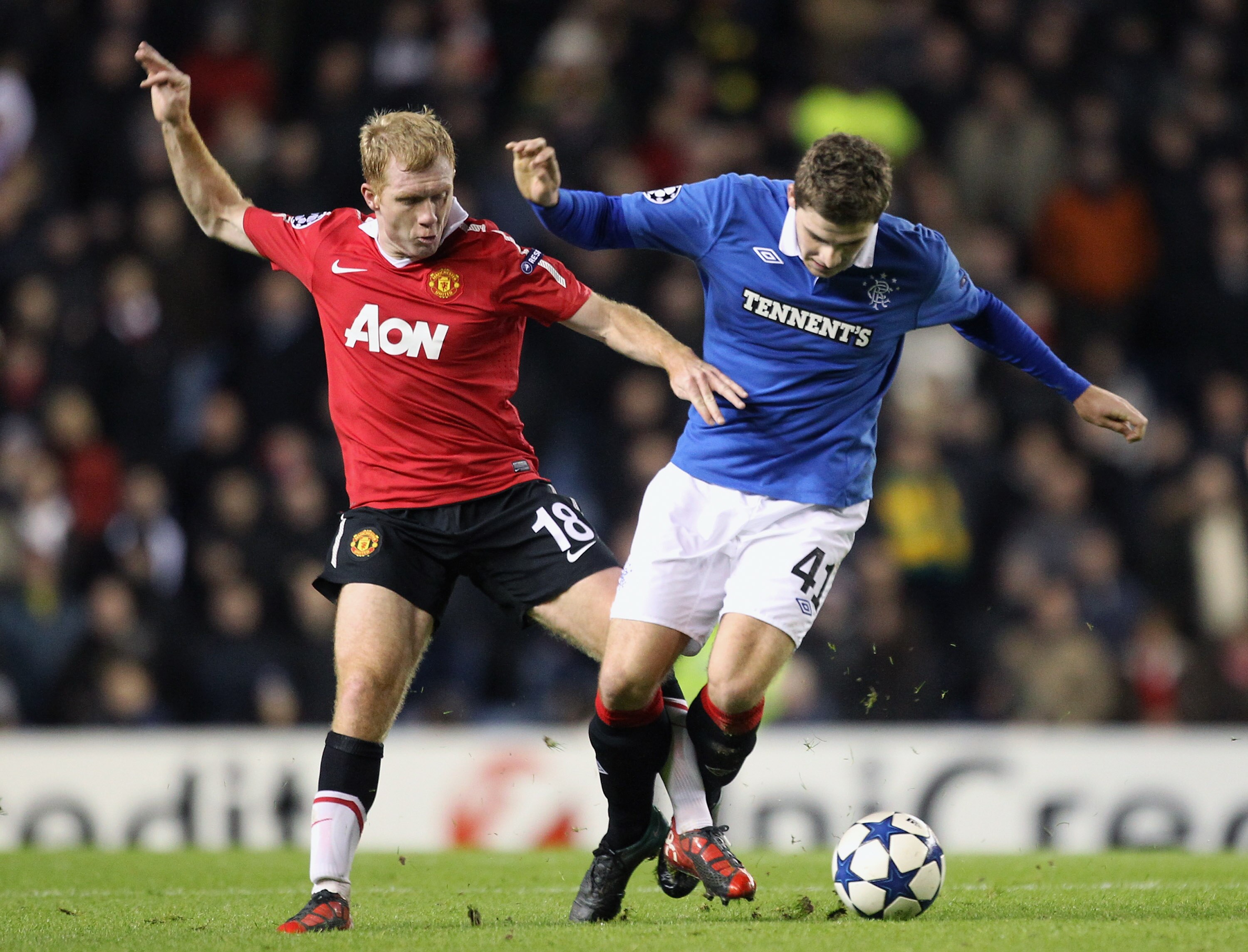 GLASGOW, SCOTLAND - NOVEMBER 24: Kyle Hutton of Rangers is challenged by Paul Scholes of Manchester United during the UEFA Champions League Group C match between Rangers and Manchester United on November 24, 2010 in Glasgow, Scotland.  (Photo by Jeff J Mi